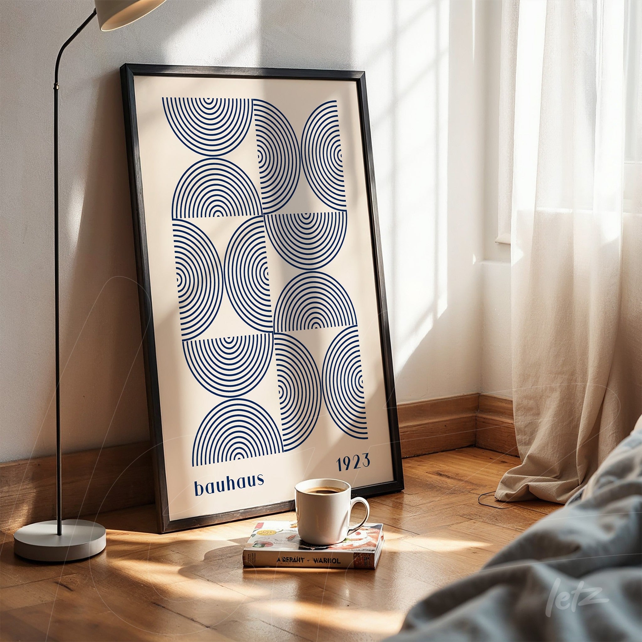 poster print featuring bauhaus geometric design in black frame resting on wooden floor