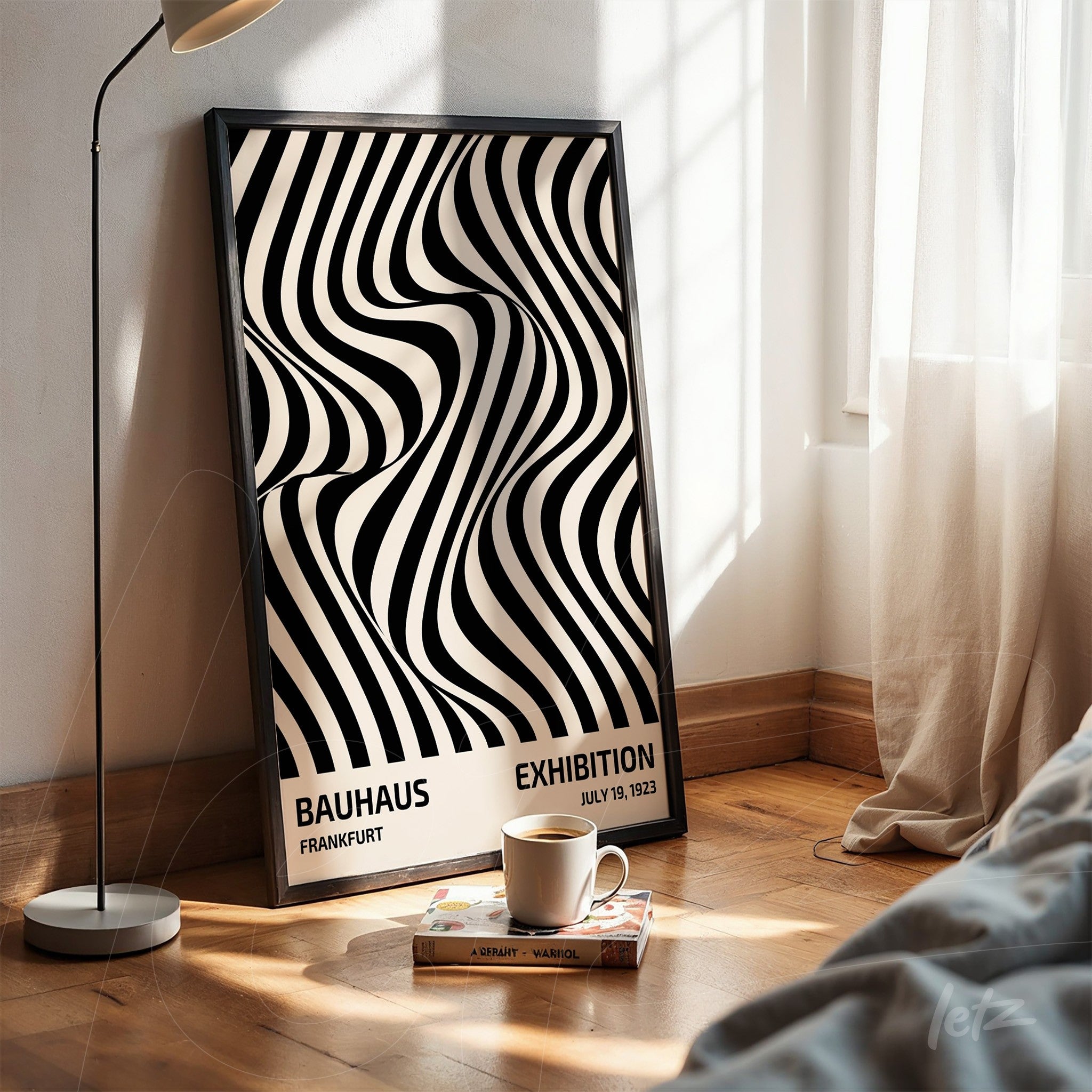 decorative wall art with black and white geometric design inspired by the Bauhaus movement, leaning on wooden floor with thin black frame