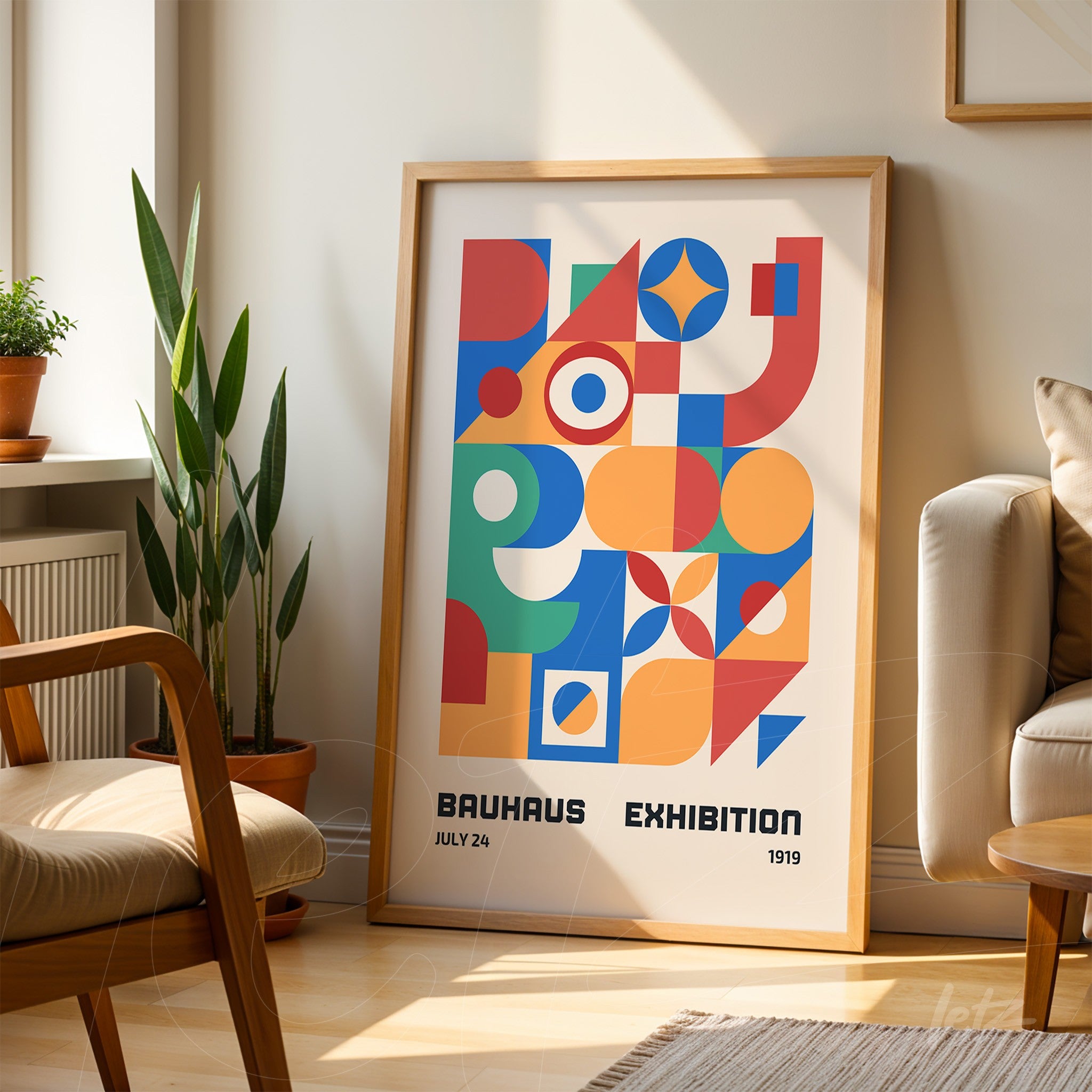 poster with colorful geometric lines and shapes in light wooden frame leaning against a wall in a naturally lit living room
