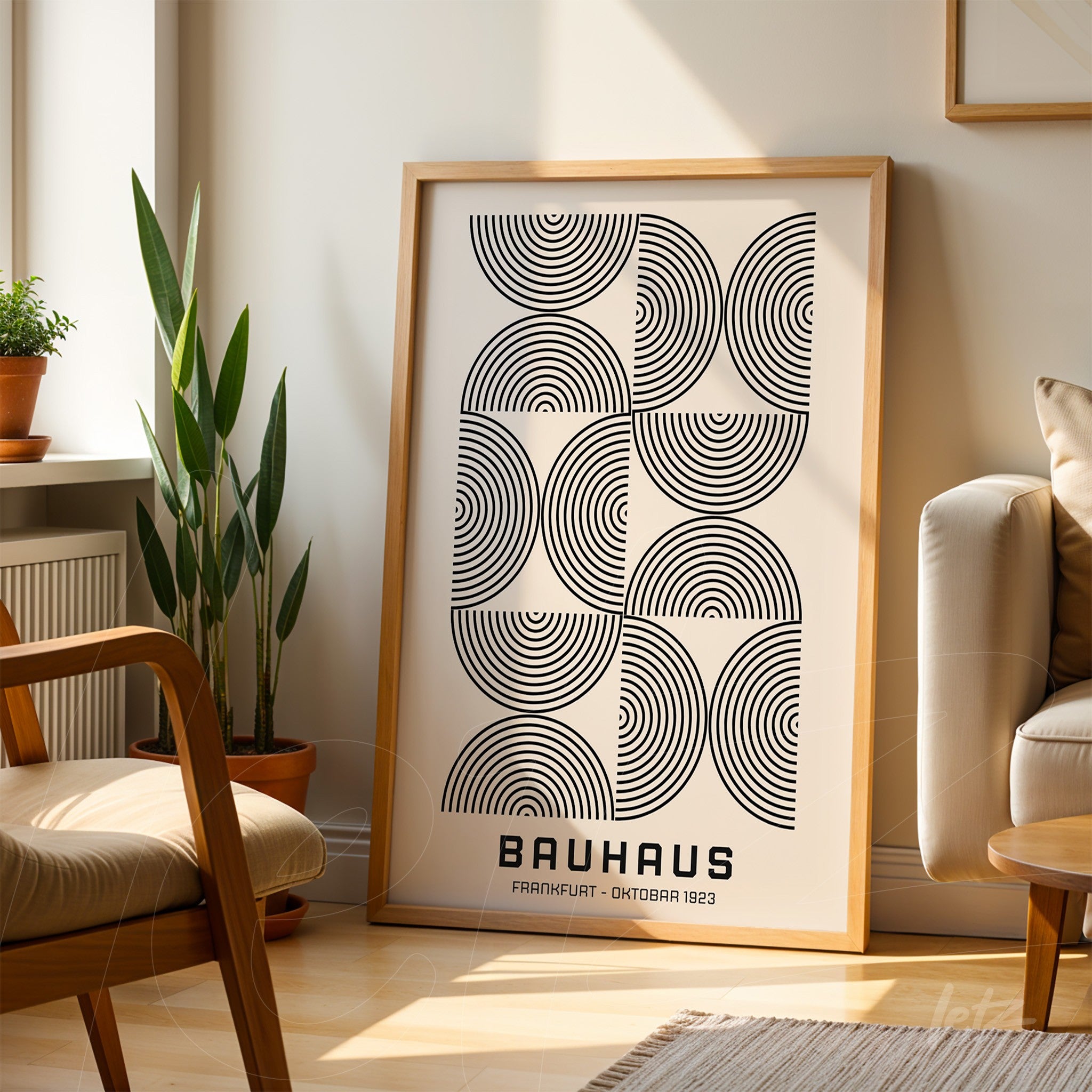 black and white geometric Bauhaus style poster print, propped in a well-lit room with a wooden frame
