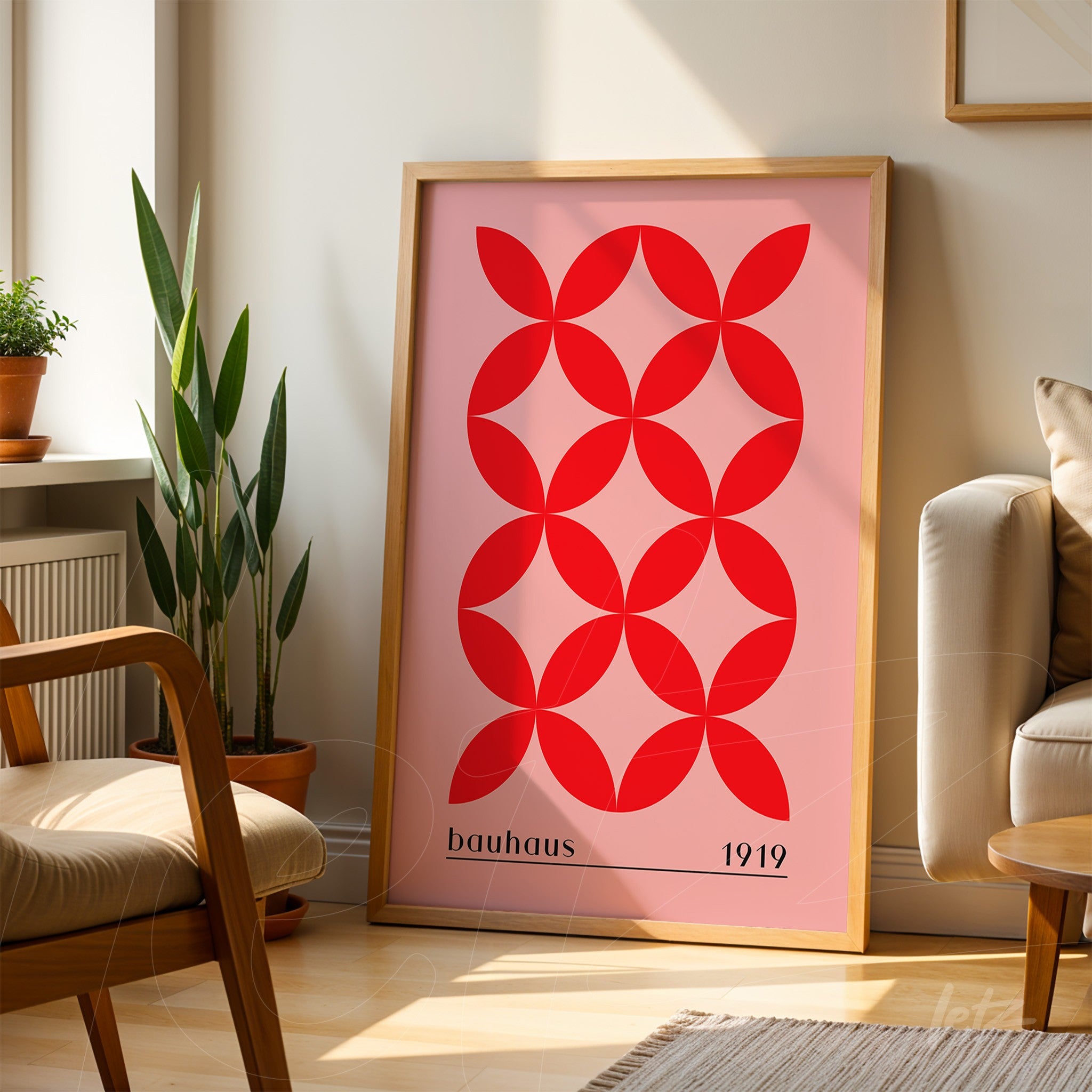 poster featuring bauhaus style geometric art in a light wood frame, displayed on wooden floor in a decorated setting
