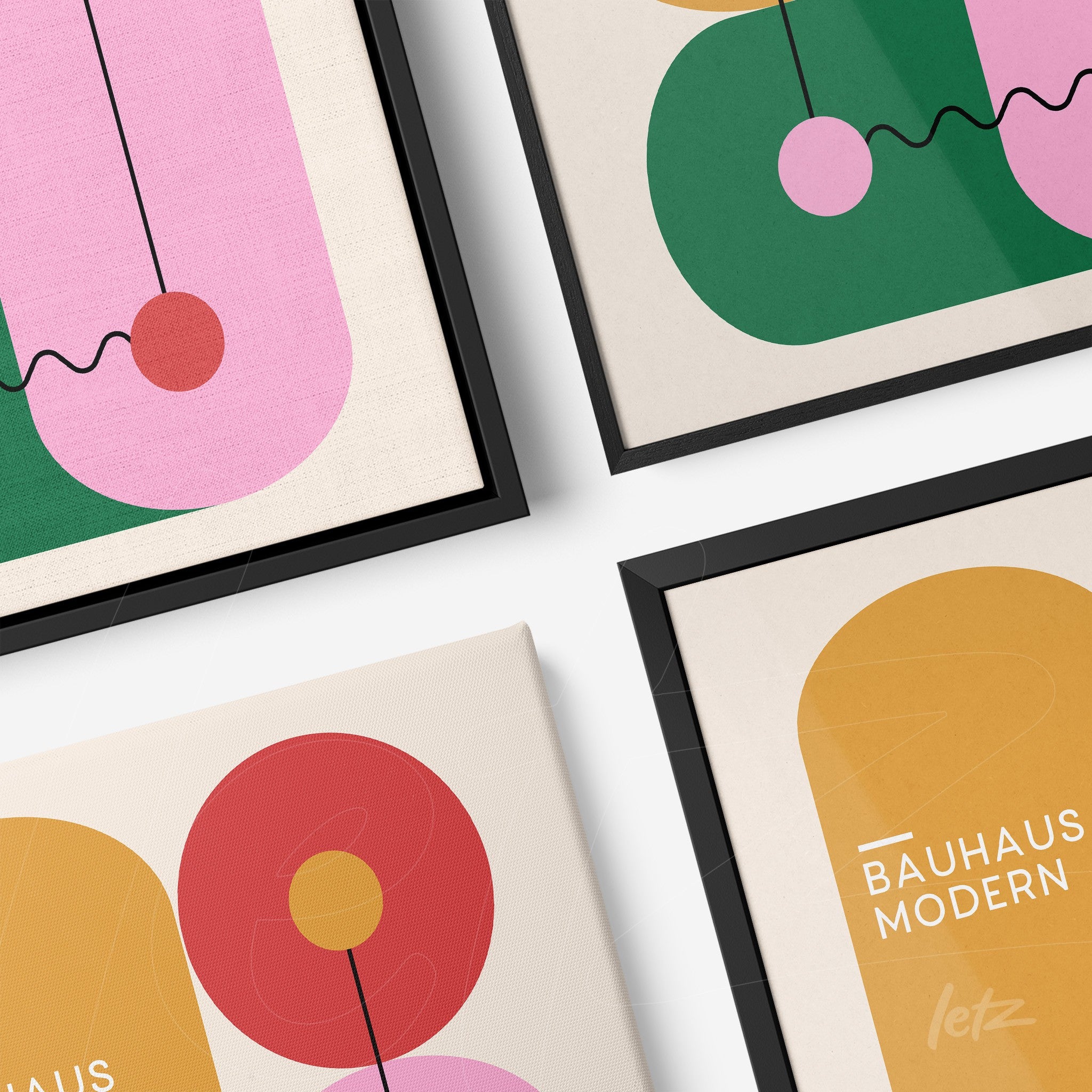 four decorative art prints featuring modern geometric designs with circular shapes and dynamic lines in black frames shown in a diagonal layout