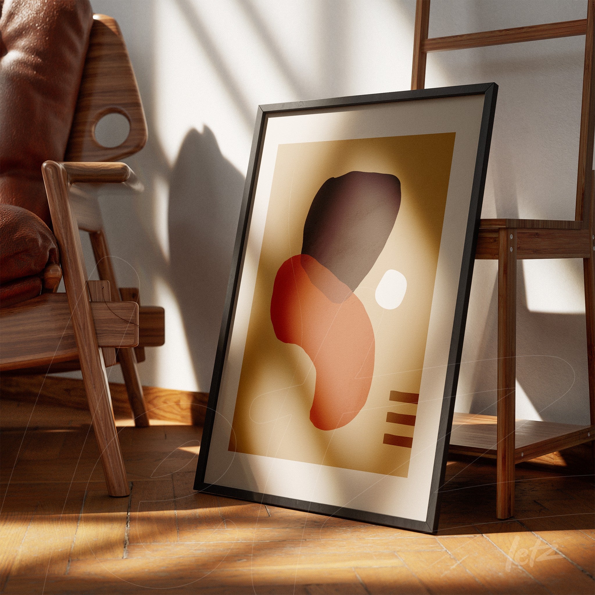 abstract art in a black frame leaning against a white wall featuring organic shapes in shades of brown and red