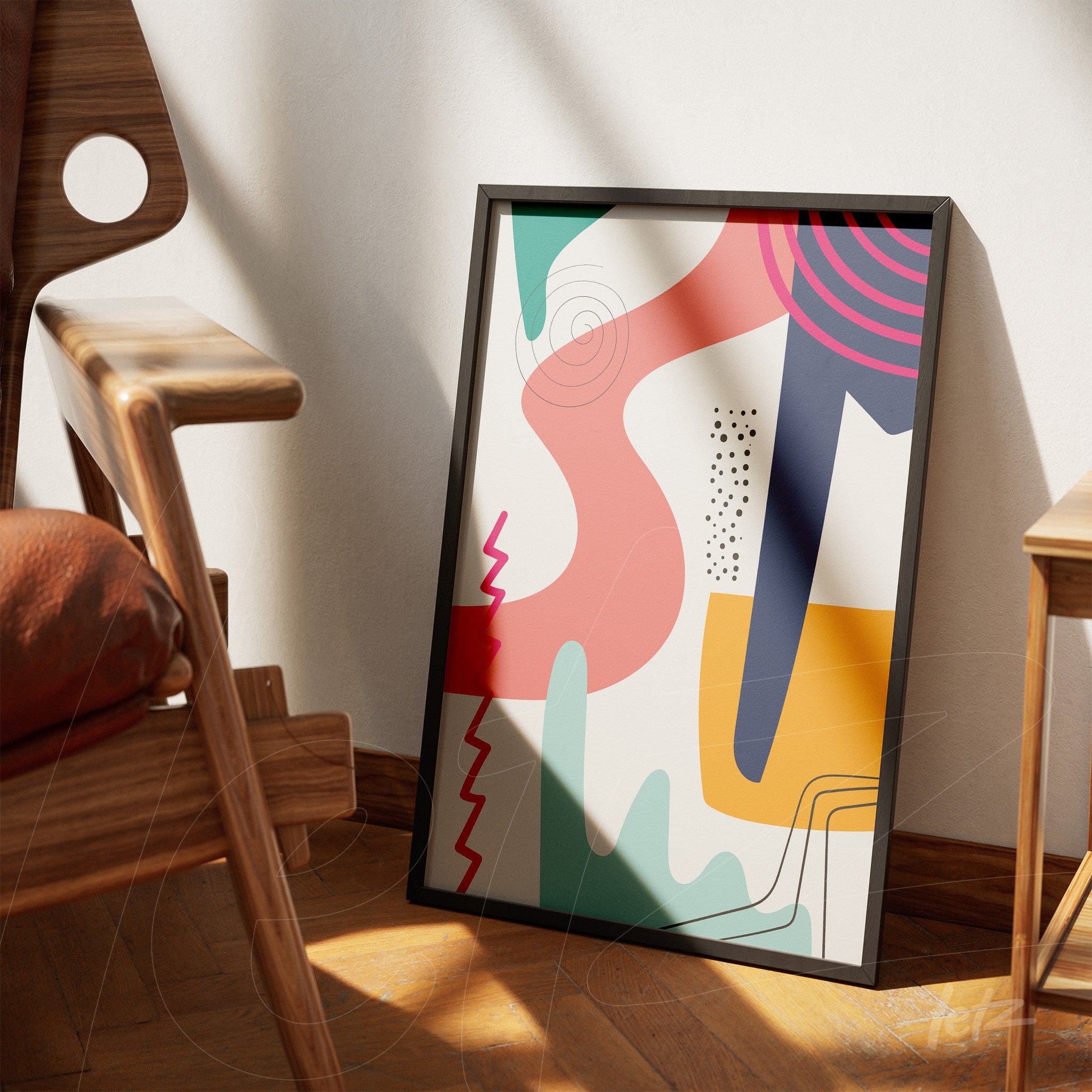 quadro apoiado em parede clara com pintura abstrata de formas geométricas coloridas e moldura preta