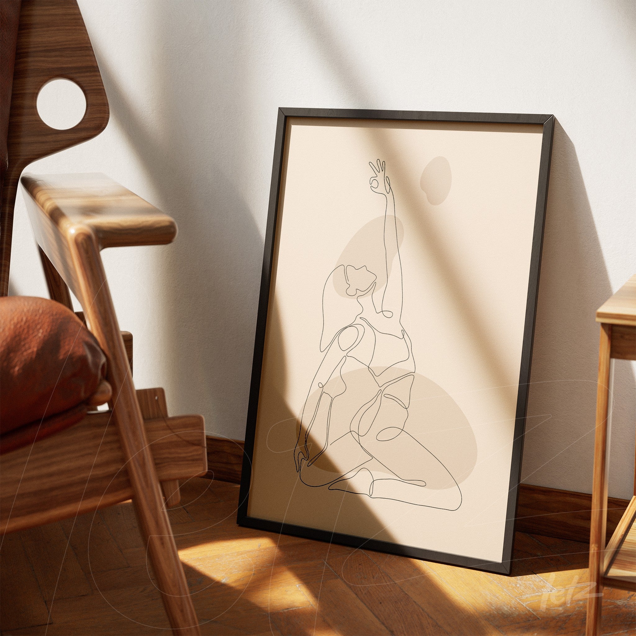 poster print showcasing continuous line drawing of a seated female figure in a yoga pose, set in a black frame, resting on a wooden floor next to a modern design chair
