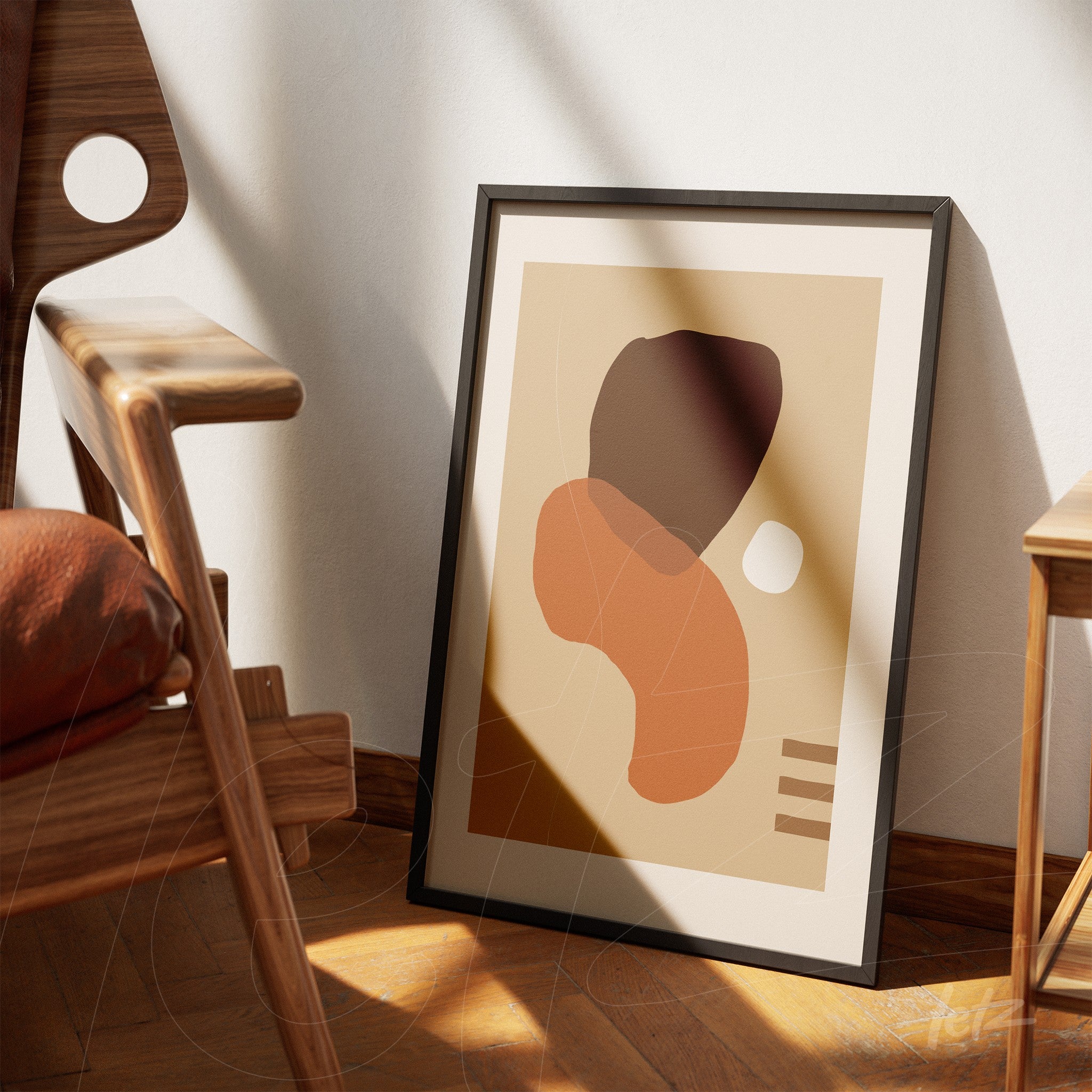 framed abstract art print in earthy tones leaning on wooden floor