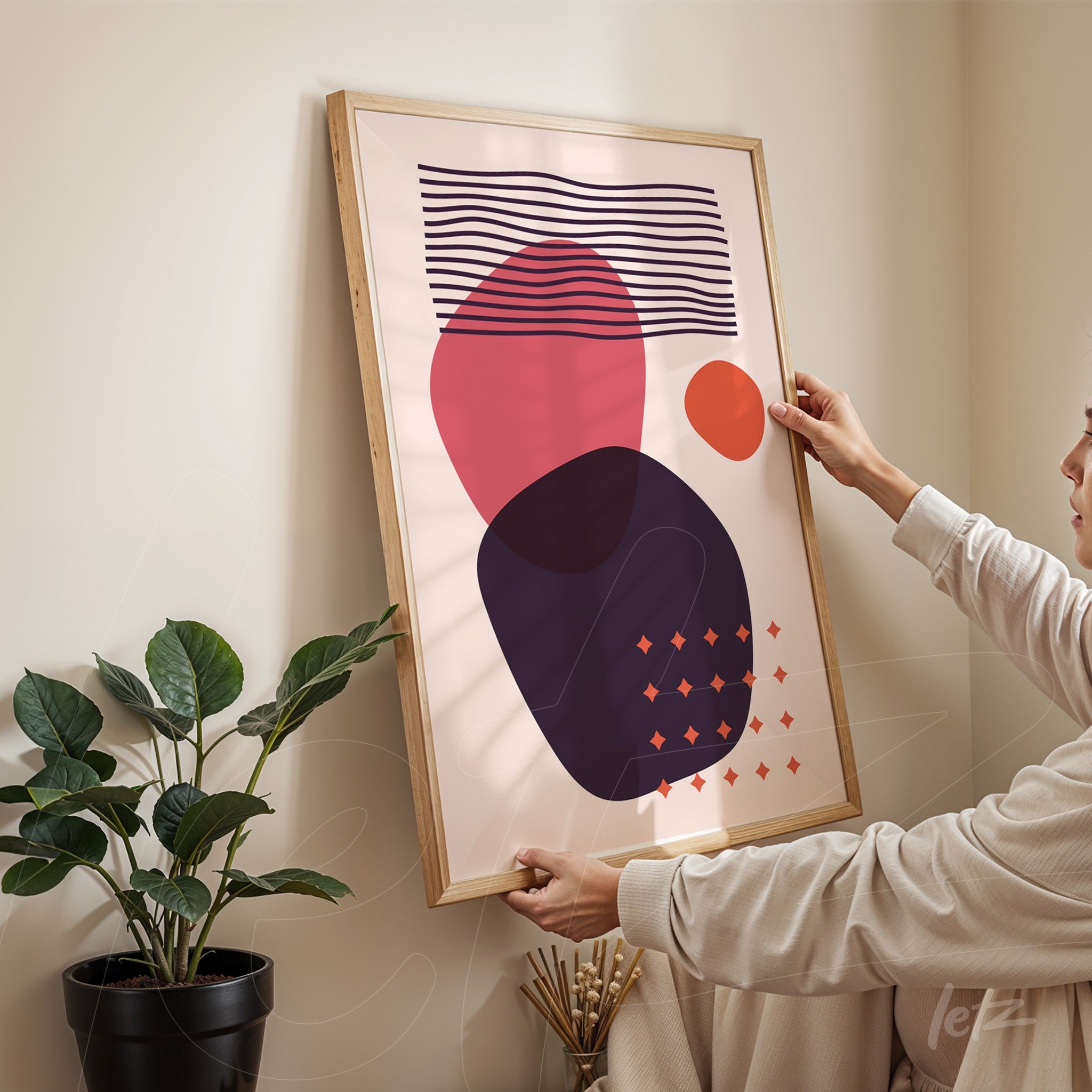 abstract wall art with colorful geometric shapes in light wood frame set against beige wall