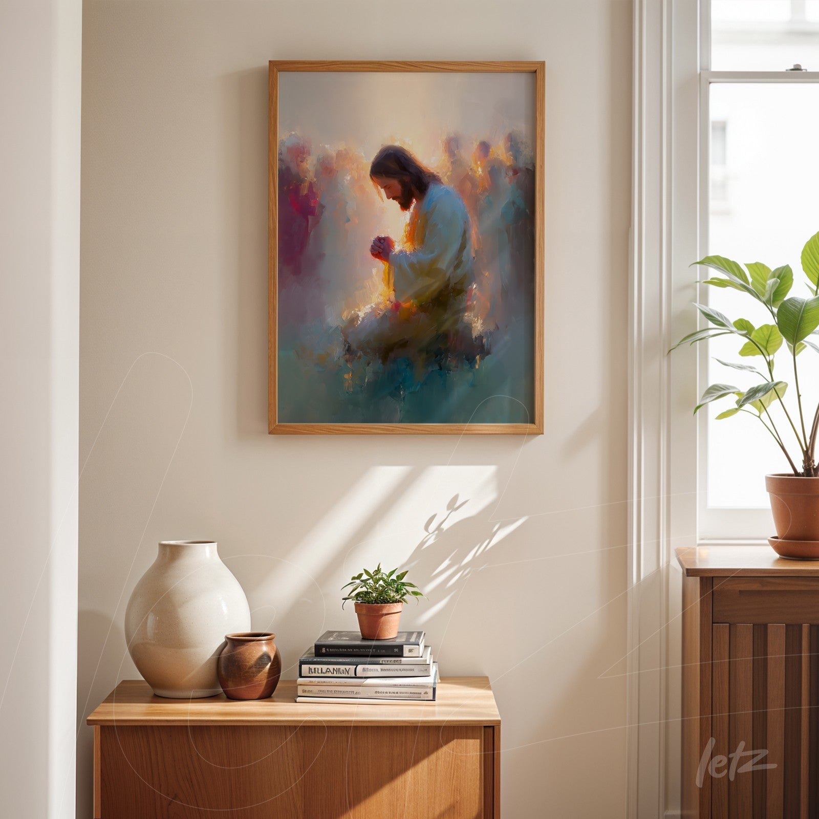 framed abstract art depicting a praying figure with soft colors and a light wooden frame