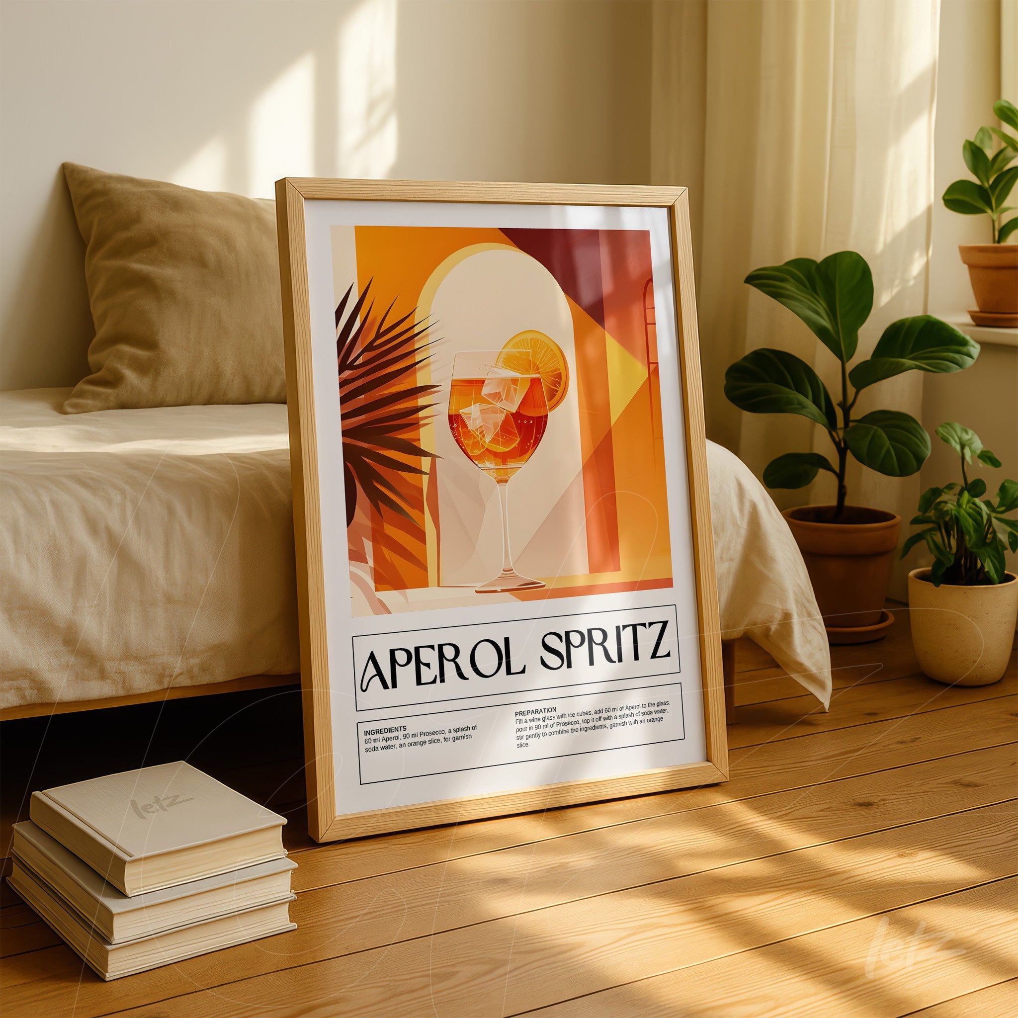 framed artwork of an aperol spritz cocktail in warm geometric tones displayed against a bed and next to indoor plants