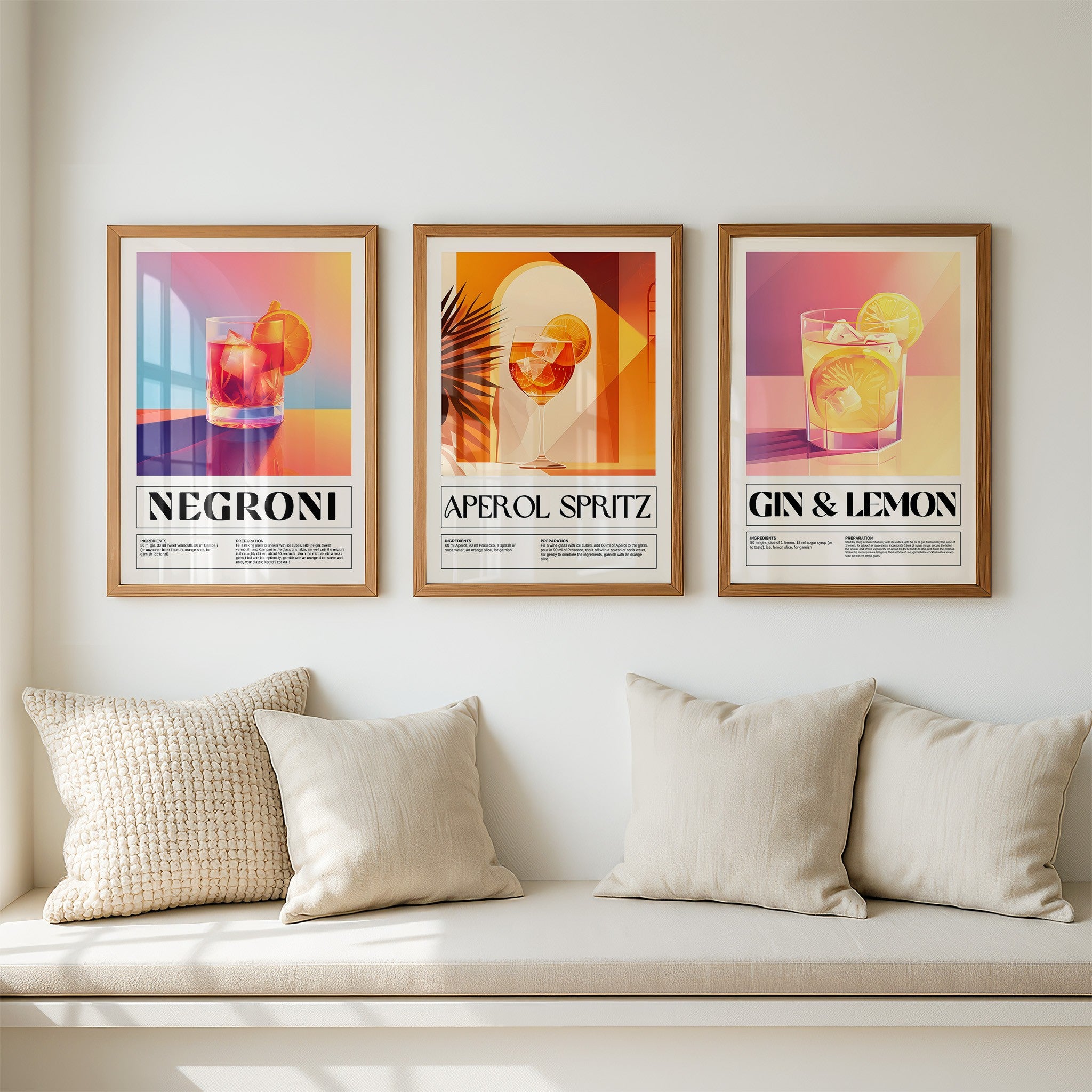 collection of three framed artworks featuring colorful cocktails including negroni, aperol spritz, and gin & lemon displayed on a light wall