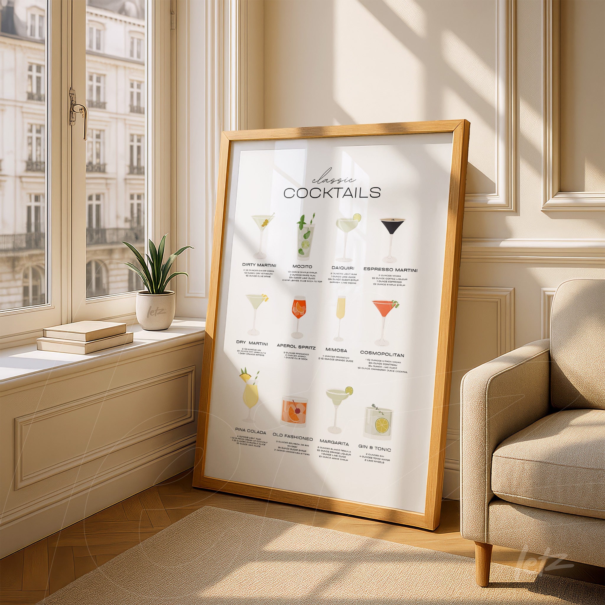 framed artwork featuring classic cocktails in light wood frame, leaning against a sunny corner beside a window