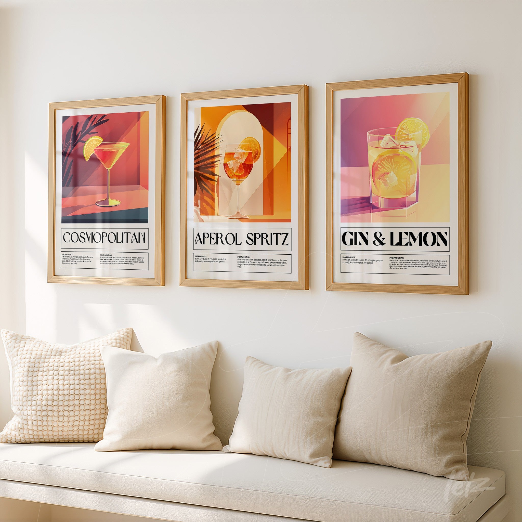 collection of three framed drinks artworks in gold frame on light wall, featuring cosmopolitan, aperol spritz, and gin with lemon illustrations