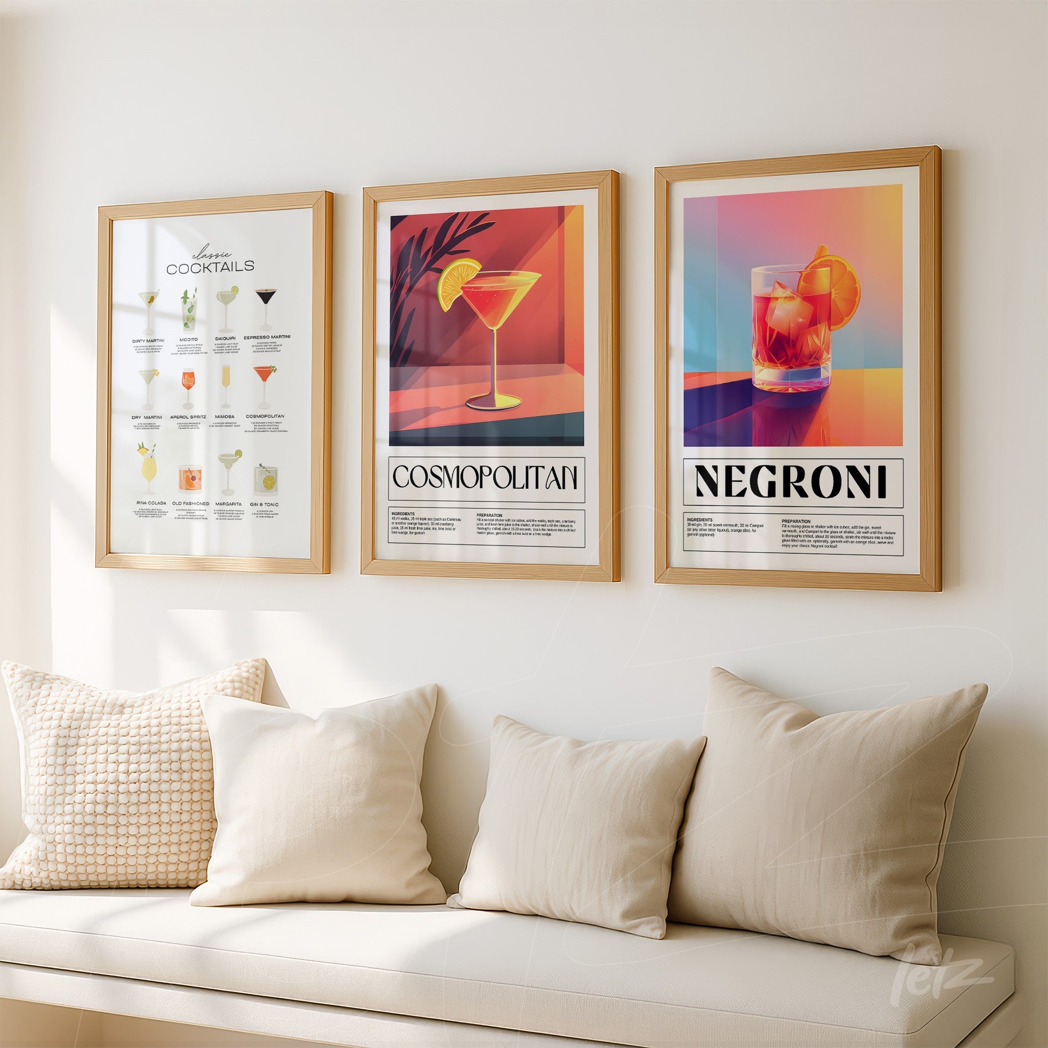 collection of decorative framed wall art showcasing cocktails with light frames, featuring cosmopolitan artwork in the center and negroni on the right