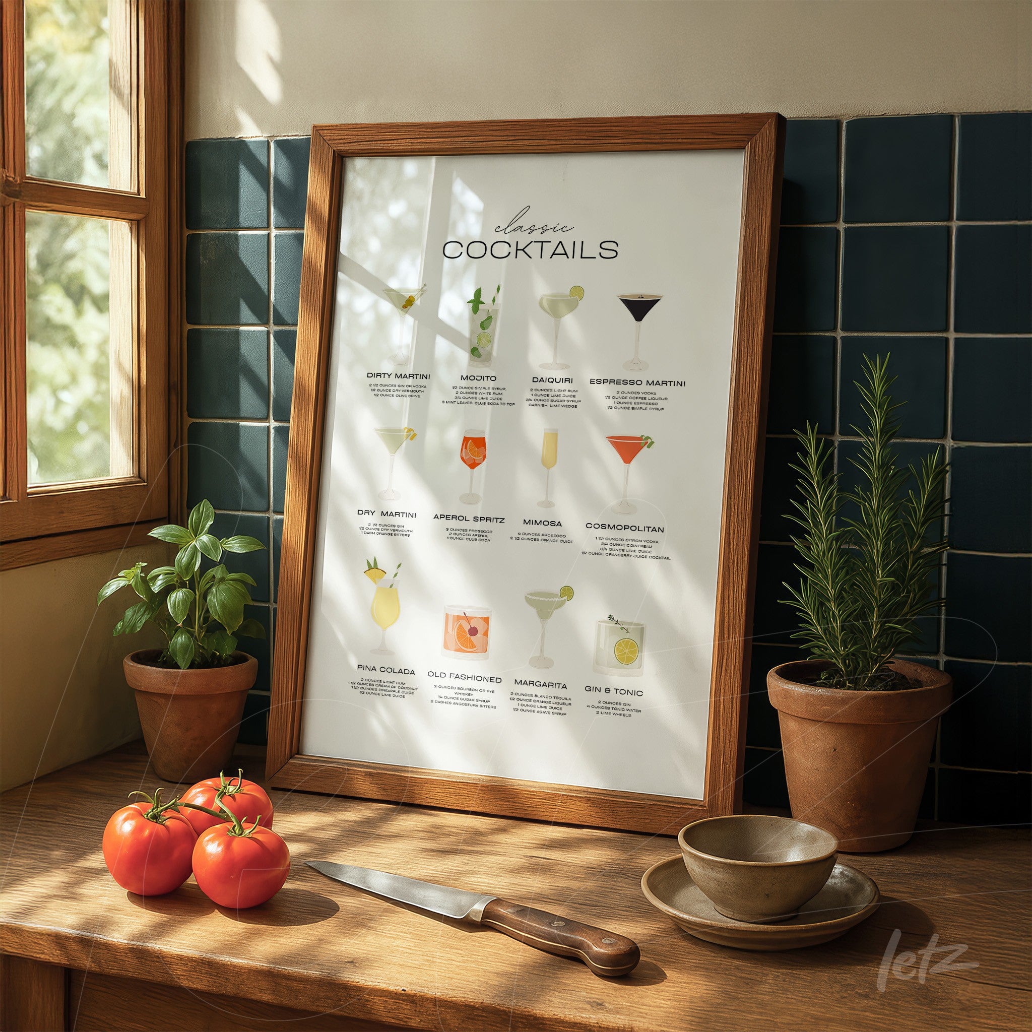 framed artwork featuring illustrations of classic cocktails on wooden table with tomatoes beside