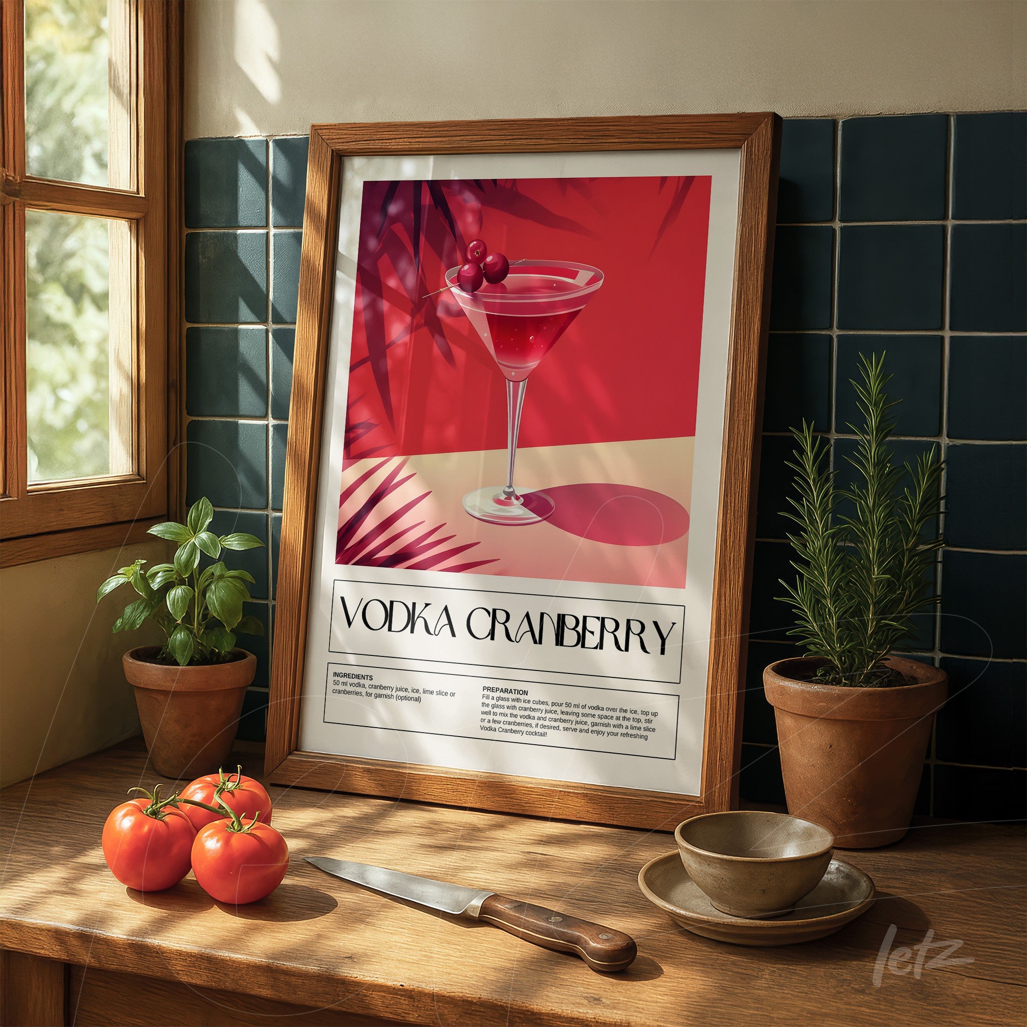 framed retro art of vodka cranberry cocktail in light wood frame on wooden table