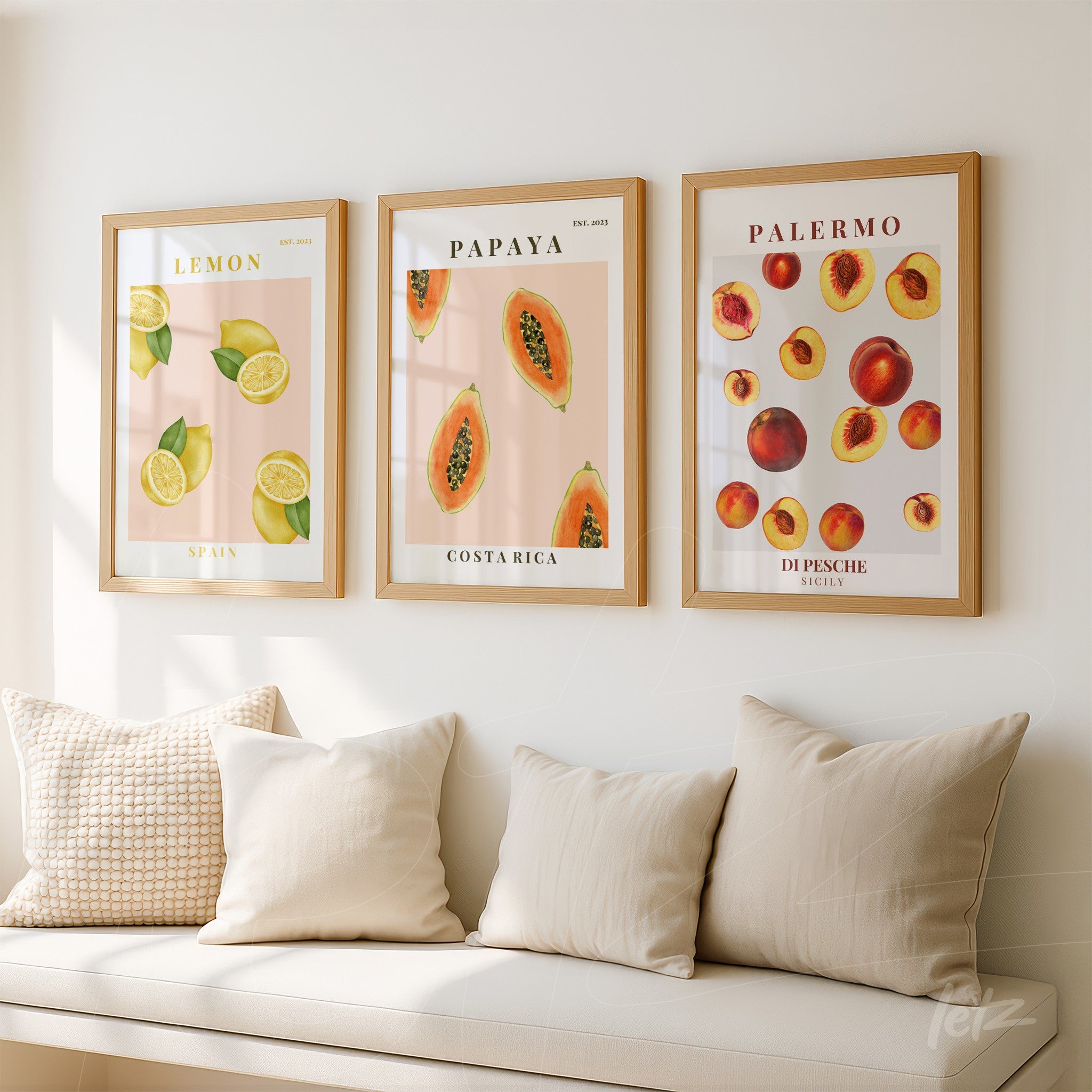 composition of decorative wall art featuring tropical fruits such as lemons, papayas, and peaches in light wood frames displayed on a light wall