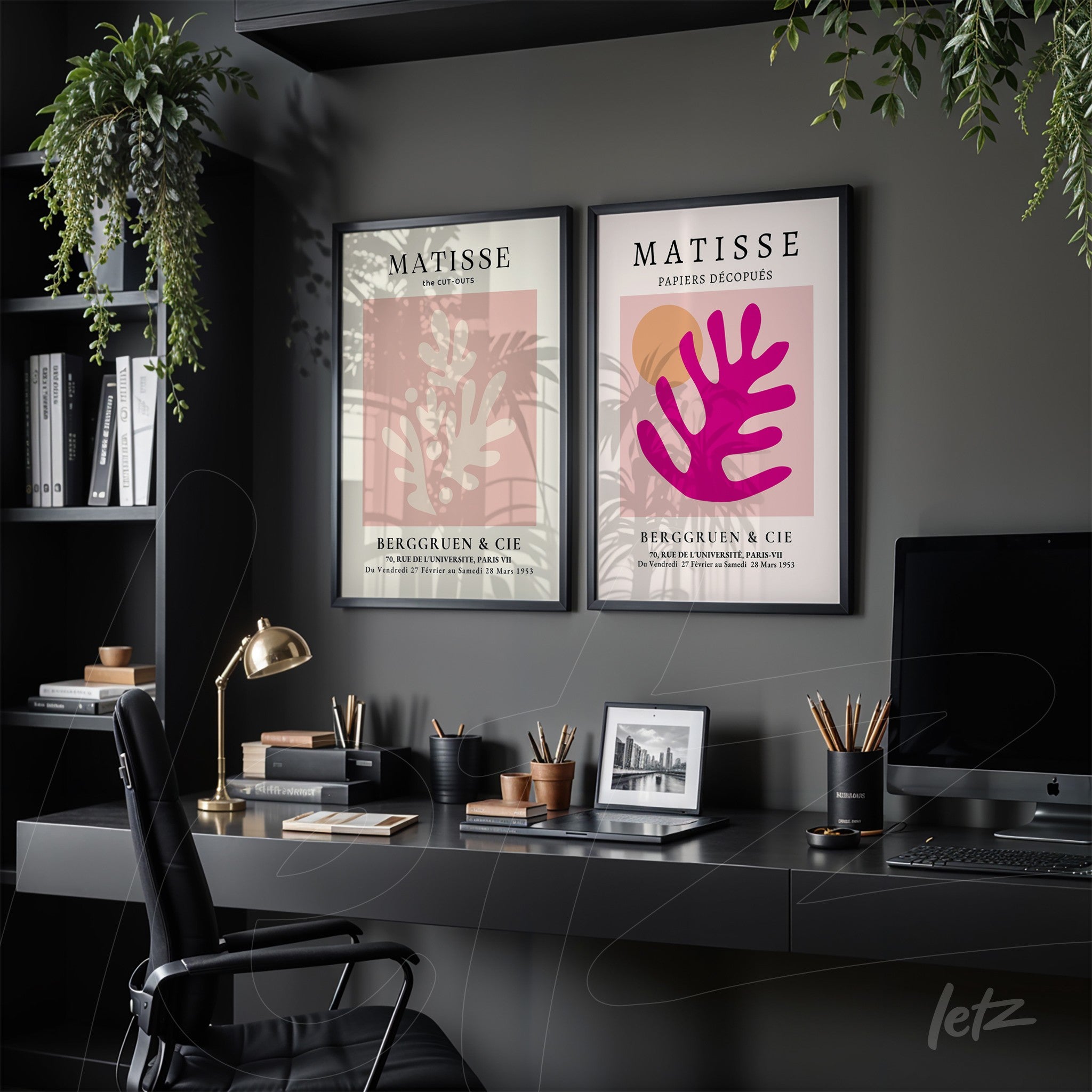collection of two framed modern art prints with black frames, one featuring a pink background with abstract foliage in pink and the other showcasing a beige background with red foliage detail, displayed in a stylish office setting with dark shelves