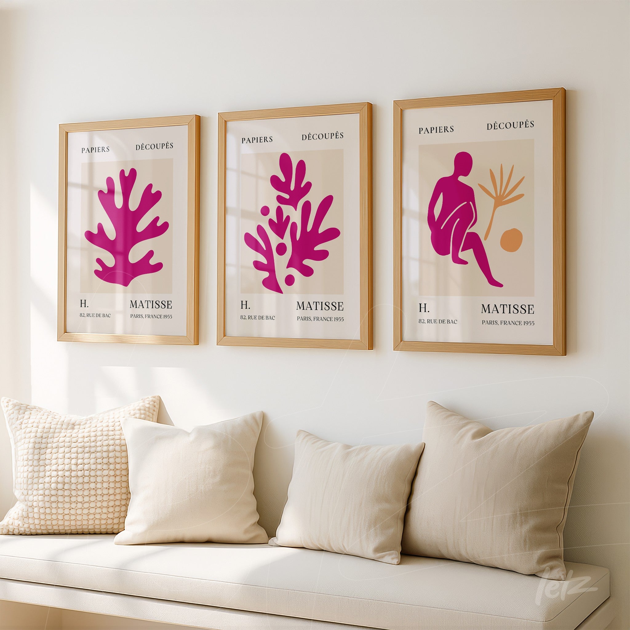 set of three decorative framed prints featuring colorful cut-outs displayed on a neutral wall