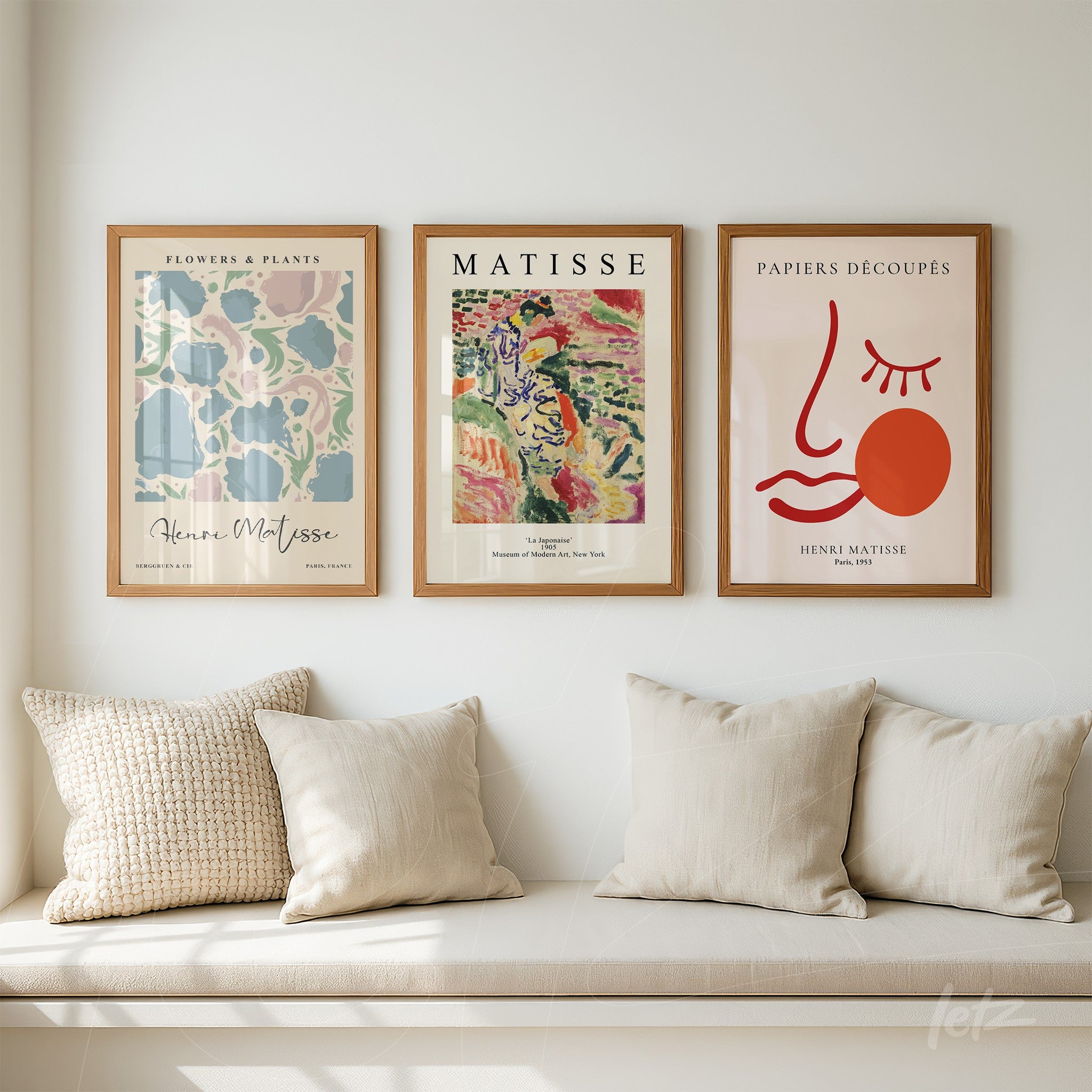 composition of three framed modern art prints in light wood frames featuring colorful illustrations inspired by Henri Matisse on a light wall