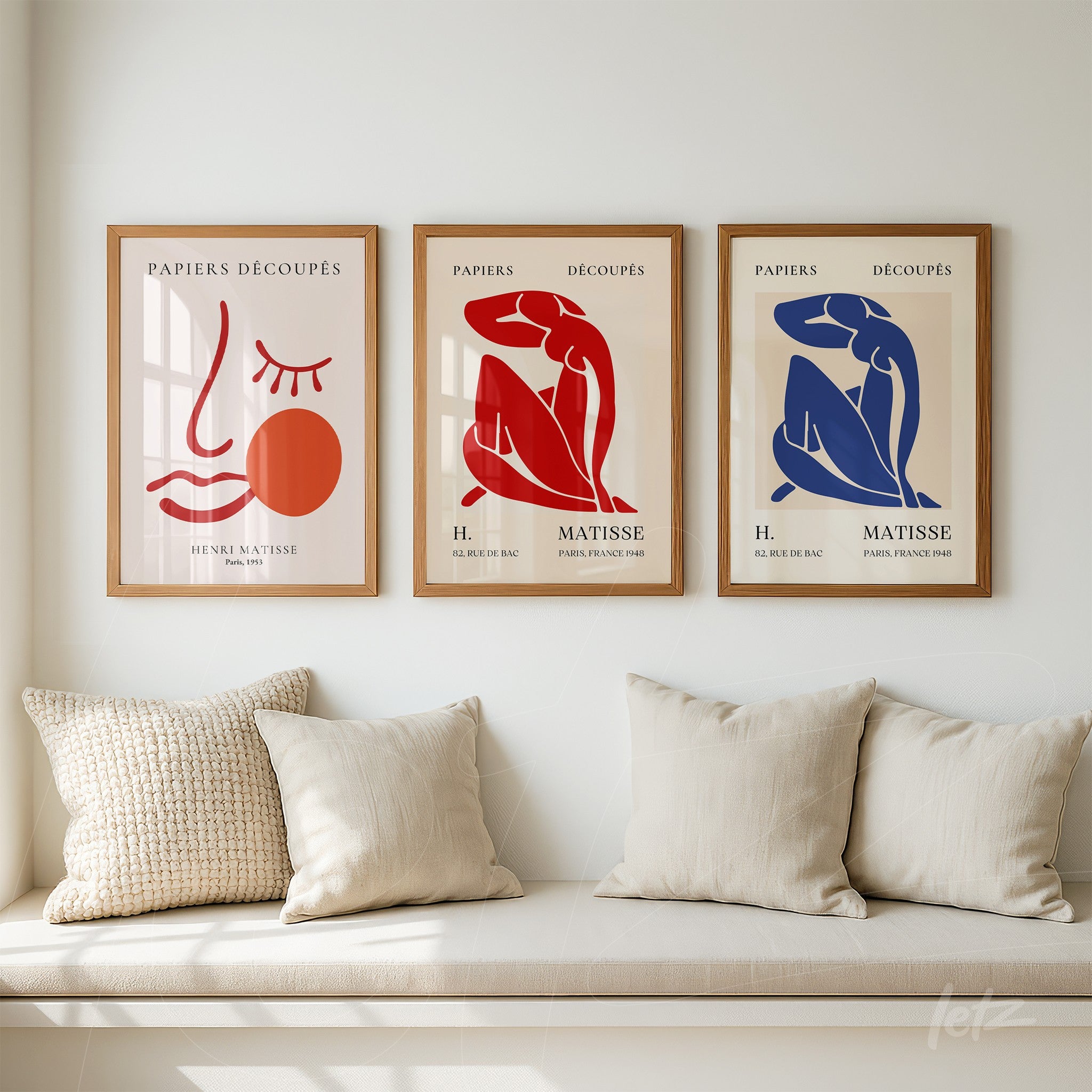 three framed wall art pieces in light wood featuring Matisse-inspired abstract illustrations in red, blue, and terracotta colors on a light background