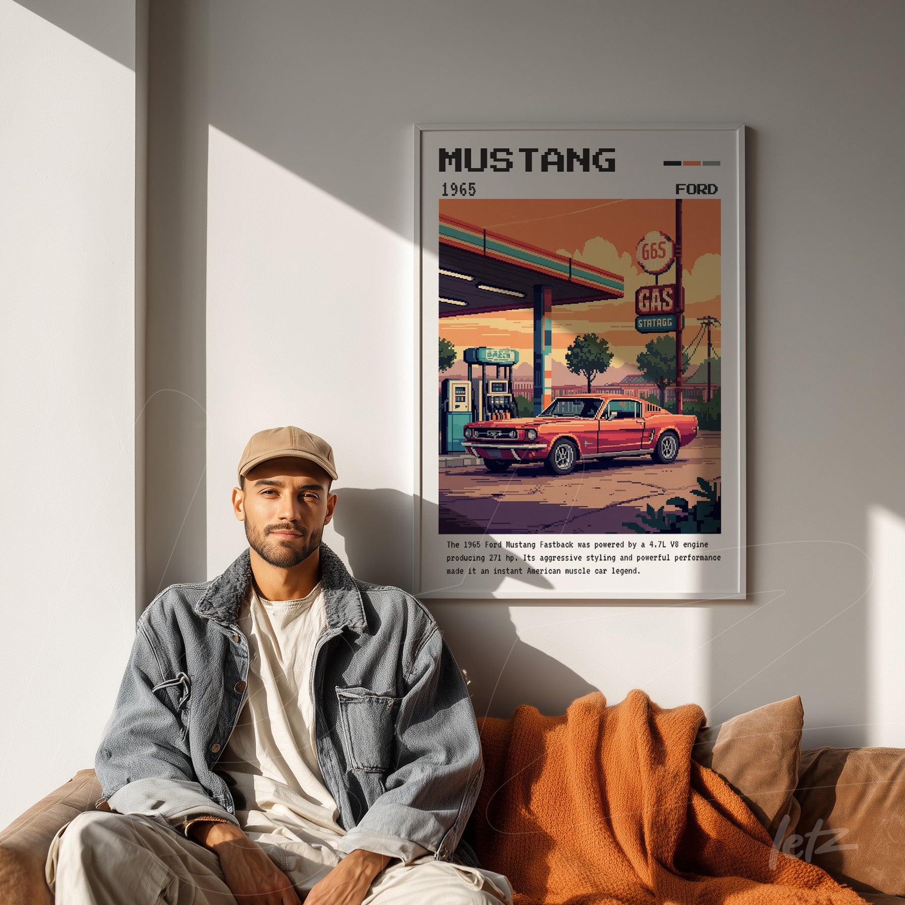 framed retro art of 1965 ford mustang displayed on a light wall with a man sitting beside it