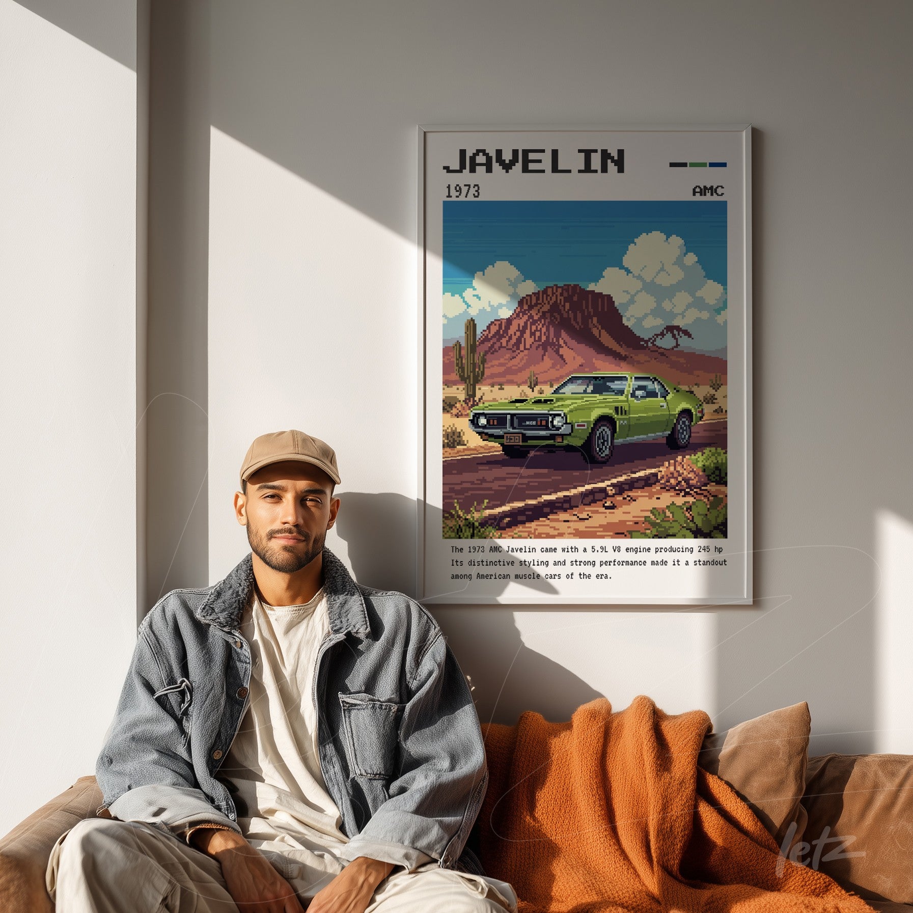 framed pixel art of 1973 Javelin car in white frame displayed on light wall next to casually dressed man