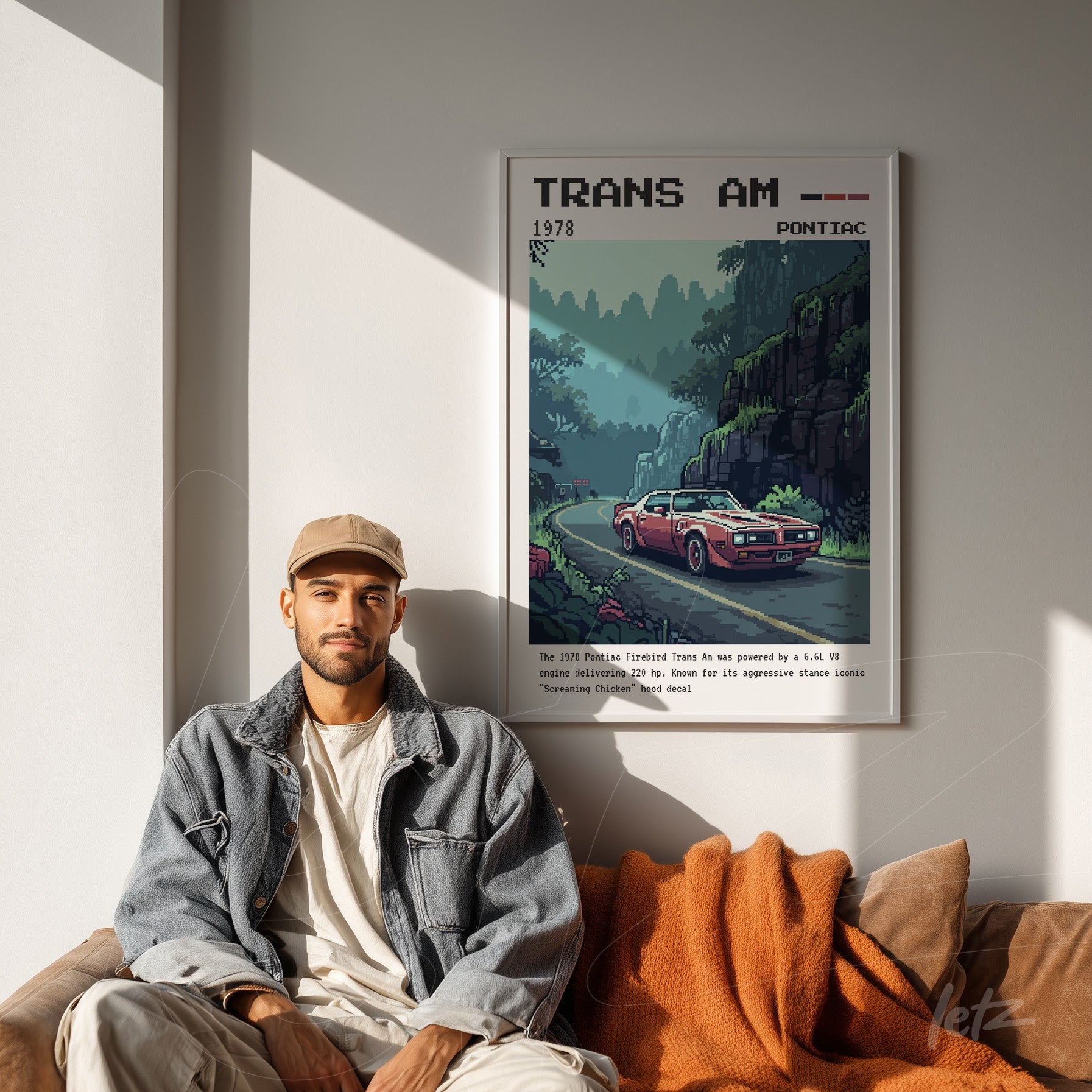 framed retro style art of a Trans Am car with white frame displayed above a beige sofa
