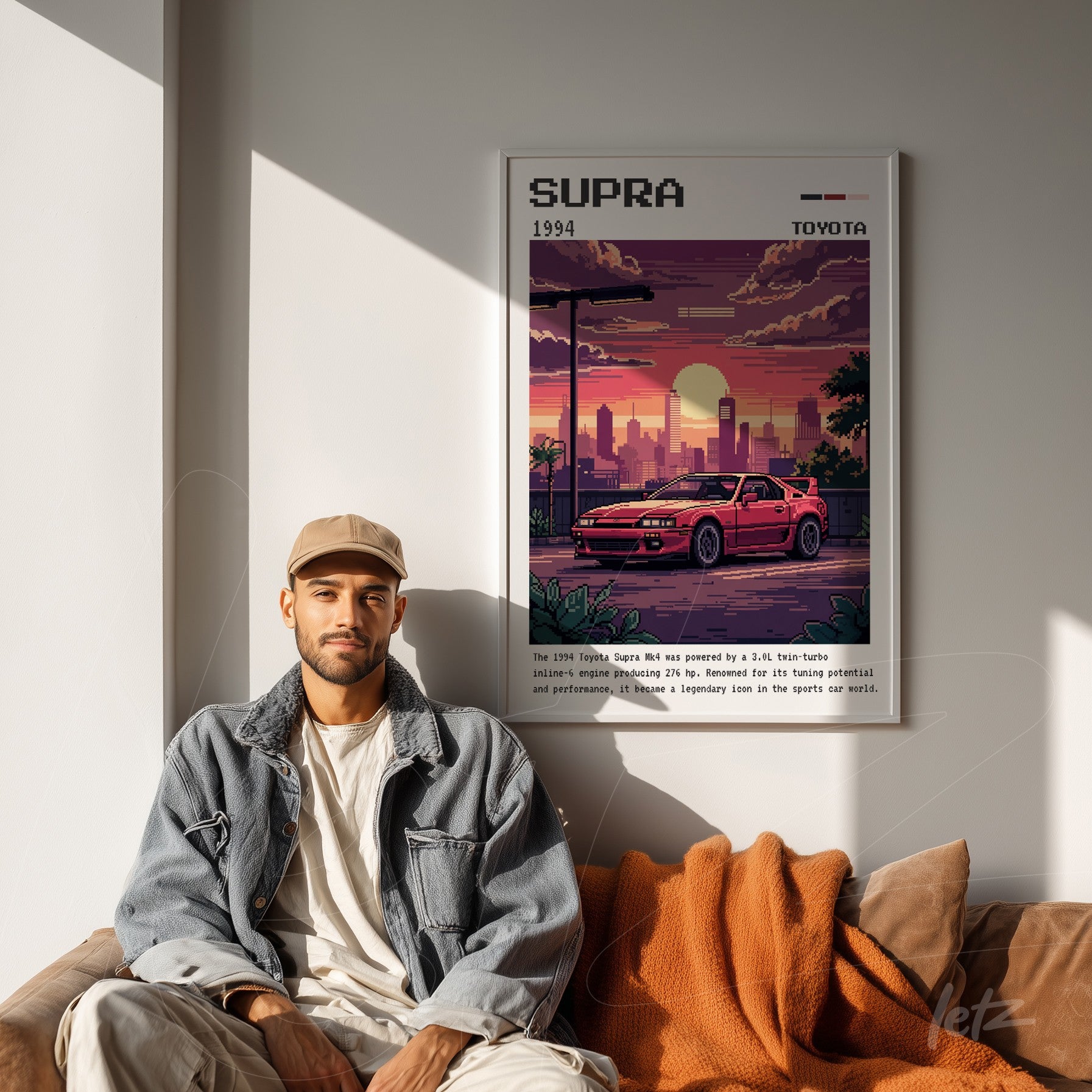 retro wall art of Toyota Supra in white frame displayed in a modern setting with orange sofa