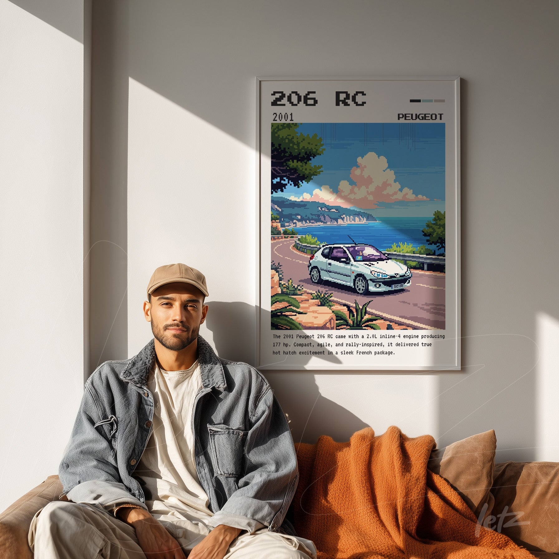 framed art featuring a digital illustration of a Peugeot 206 RC in a coastal scene, displayed on a light wall beside a man sitting on a sofa