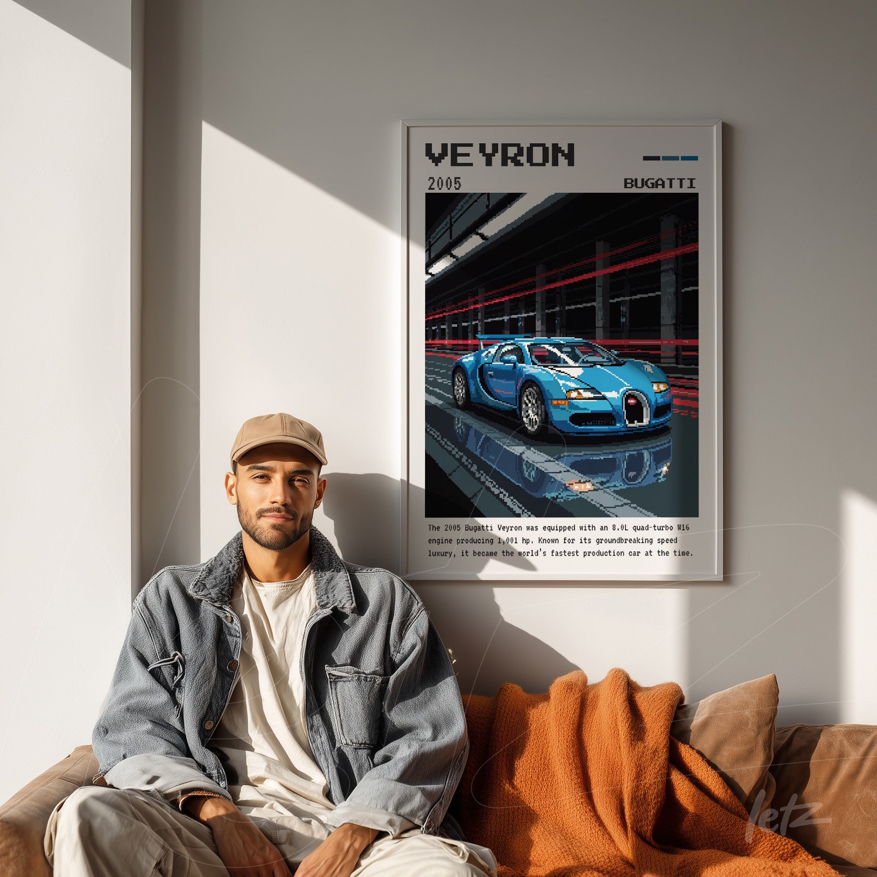 framed retro style digital art of a Bugatti Veyron car with white frame displayed on gray wall next to a man sitting on a light sofa