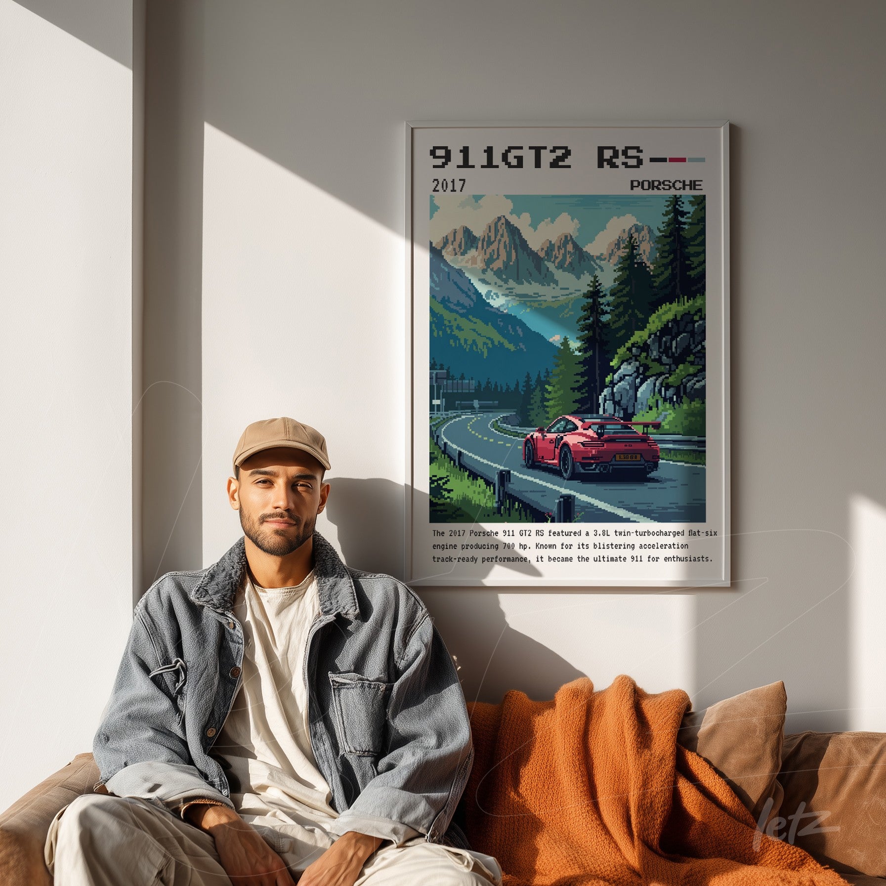 framed pixel art of a Porsche 911 GT2 RS displayed on a light wall with a man sitting beside it in a cozy setting