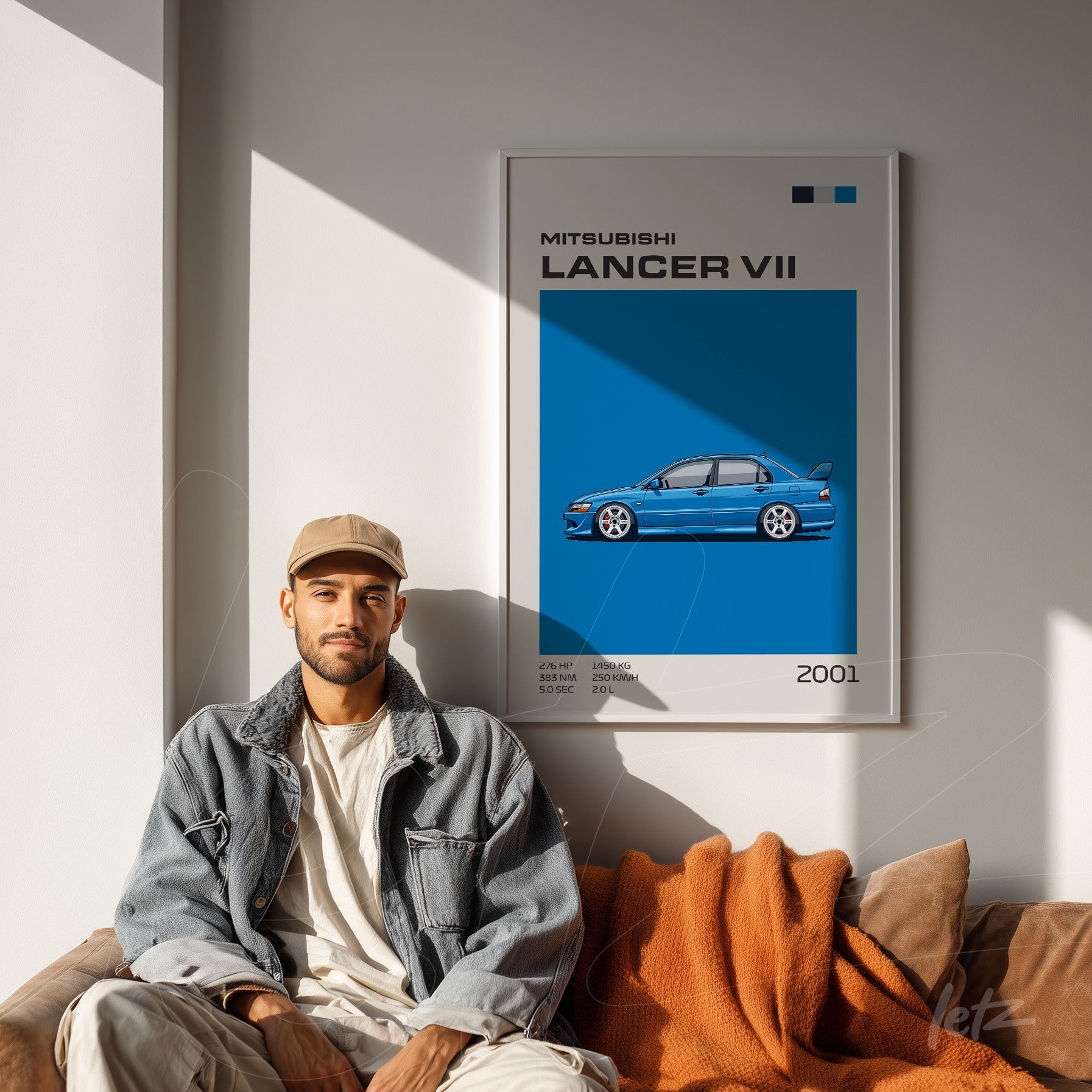 framed wall art featuring an illustration of the Mitsubishi Lancer VII against a blue background, displayed on a light wall with a seated person on a sofa