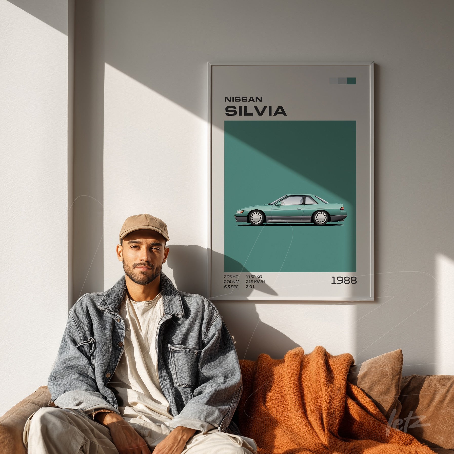 framed wall art of Nissan Silvia car in a white frame displayed beside a man sitting on a sofa in casual attire