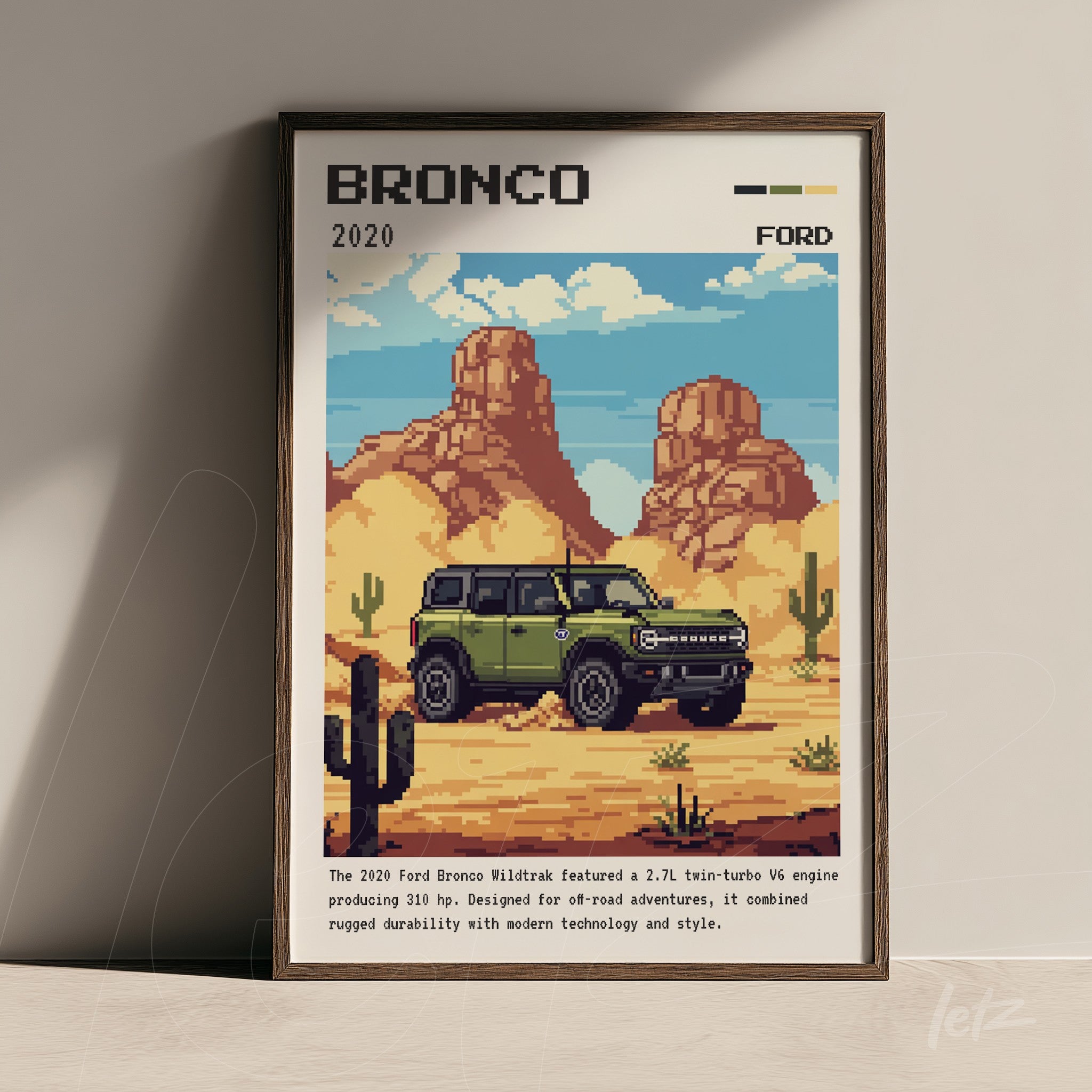 pixel art framed wall art of the 2020 Ford Bronco in a desert landscape with cacti and mountains in the background, dark wood frame