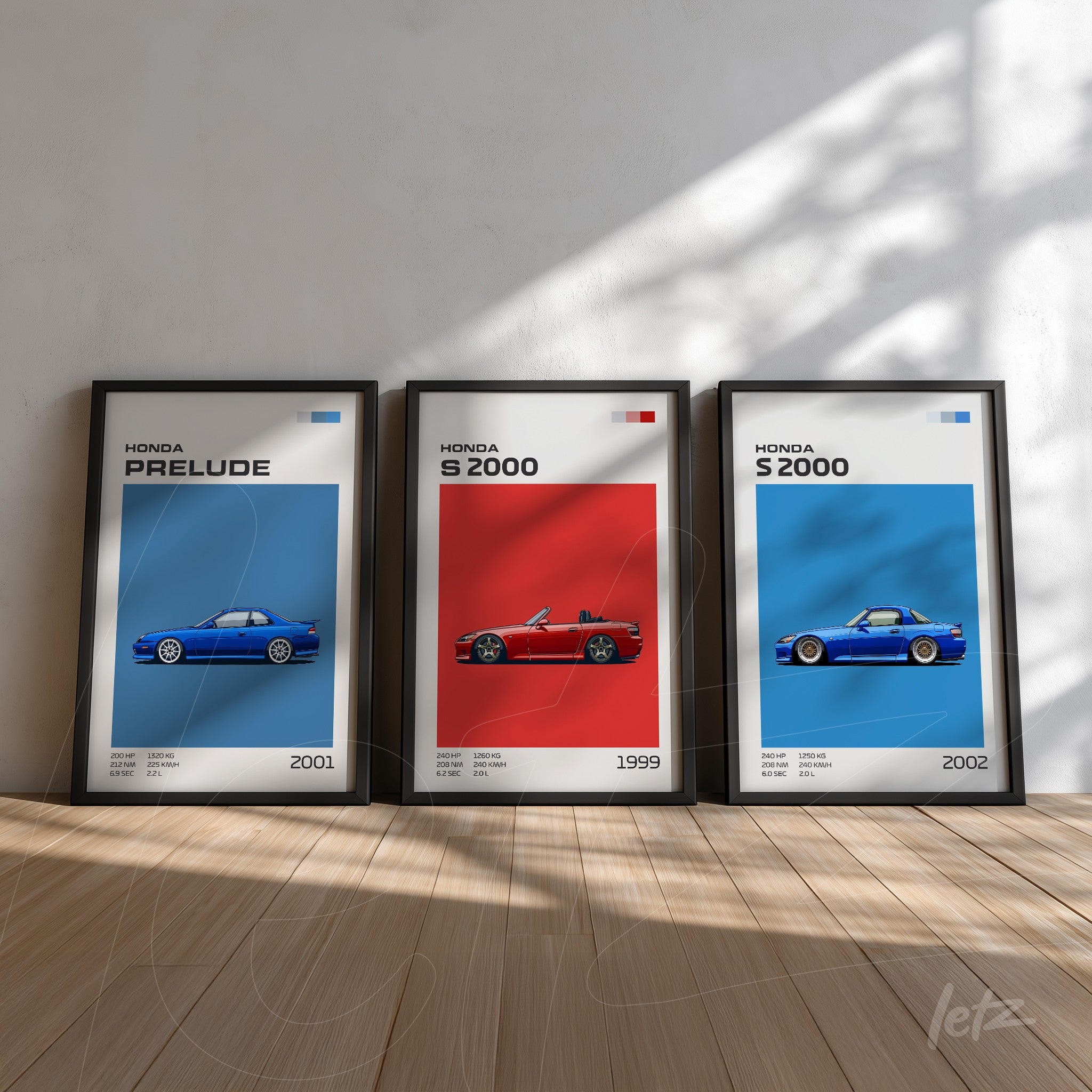 collection of framed art featuring Honda car illustrations, including a blue Prelude on a blue background, a red S2000 on a red background, and another blue S2000 on a white background, all in black frames