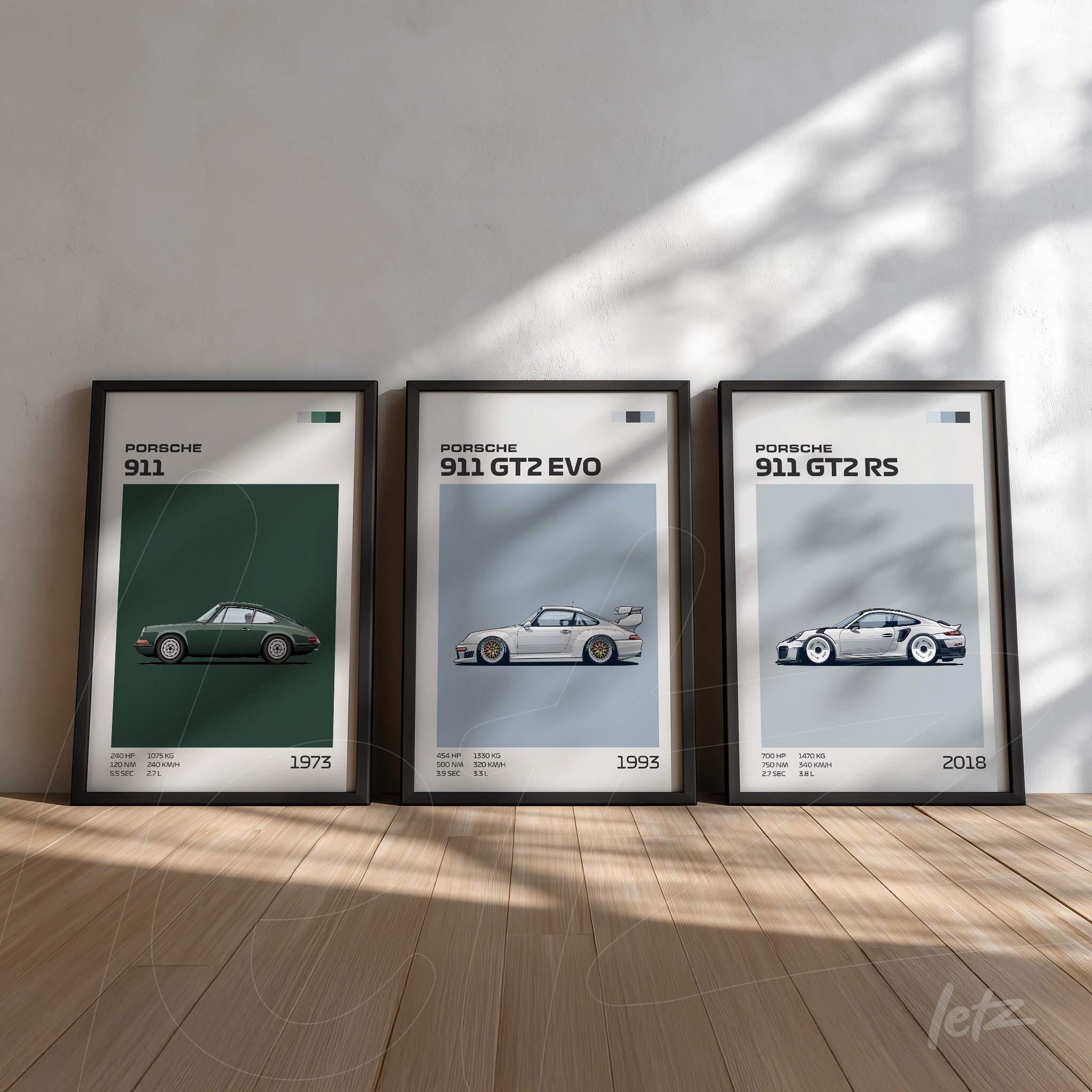 collection of three framed wall art featuring Porsche cars, including a 1973 model 911, a 1993 911 GT2 EVO, and a 2018 911 GT2 RS, all in black frames with light backgrounds and natural lighting