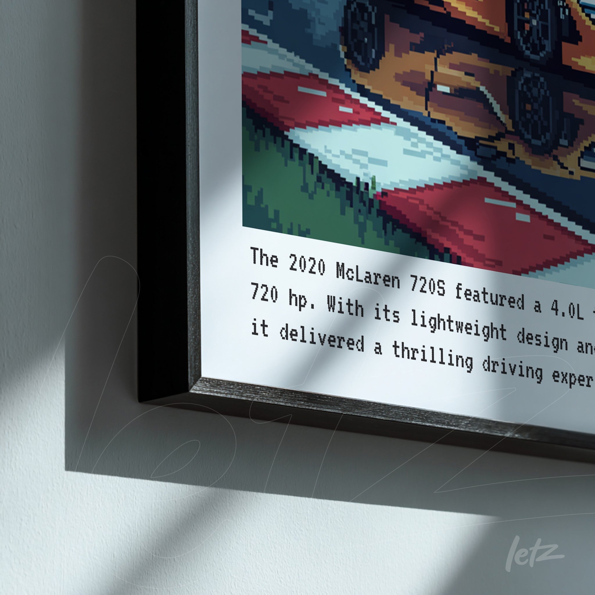 framed artwork featuring a pixelated illustration of a racing car on a colorful background with a text description at the bottom
