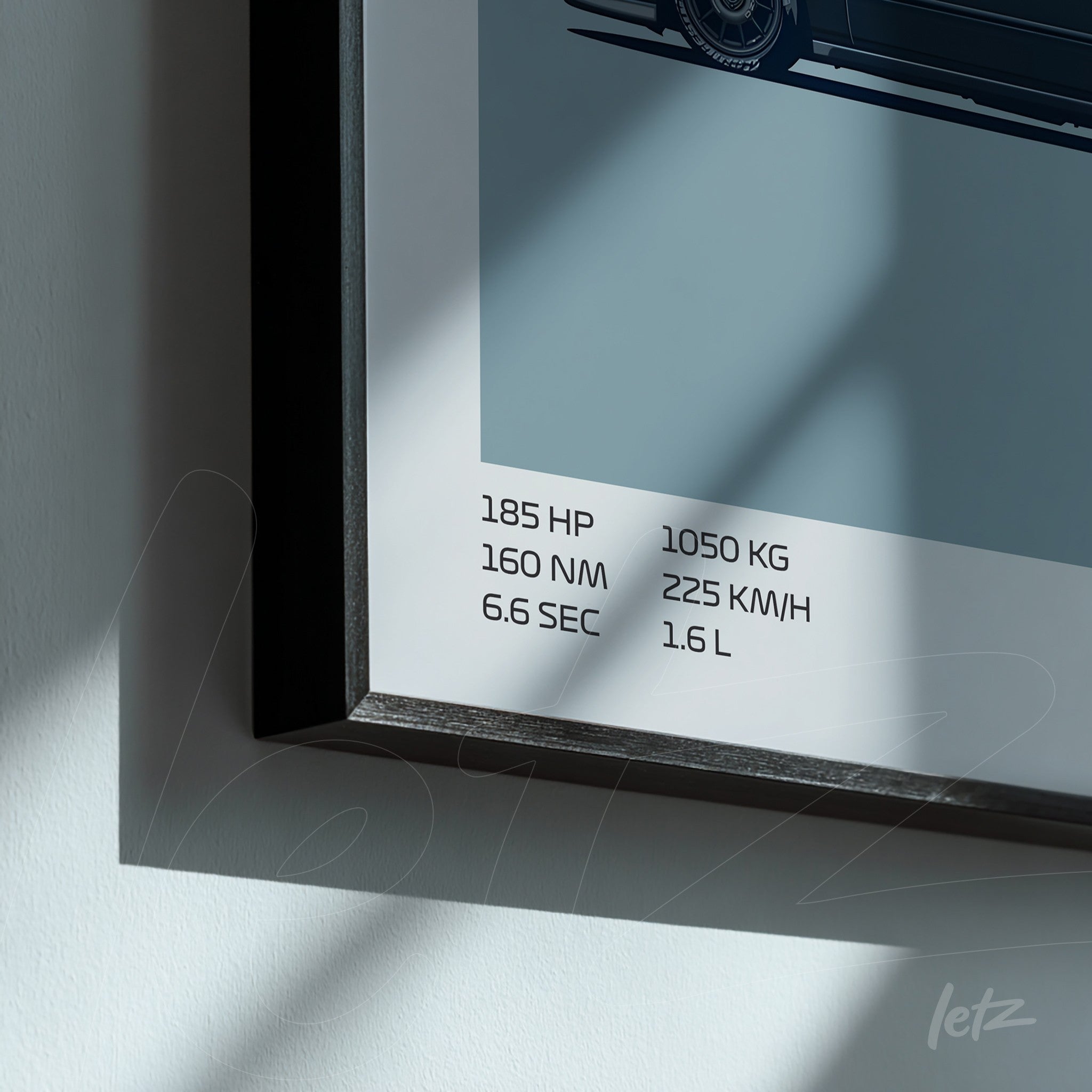 framed wall art featuring a graphic of a sports car with technical specifications beside it, black frame
