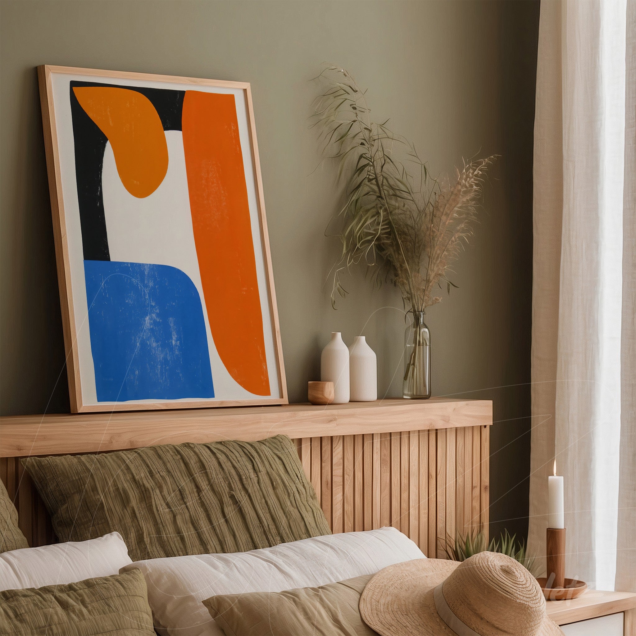 abstract art piece in blue and orange tones in a light wood frame displayed on a wooden headboard with earthy toned pillows