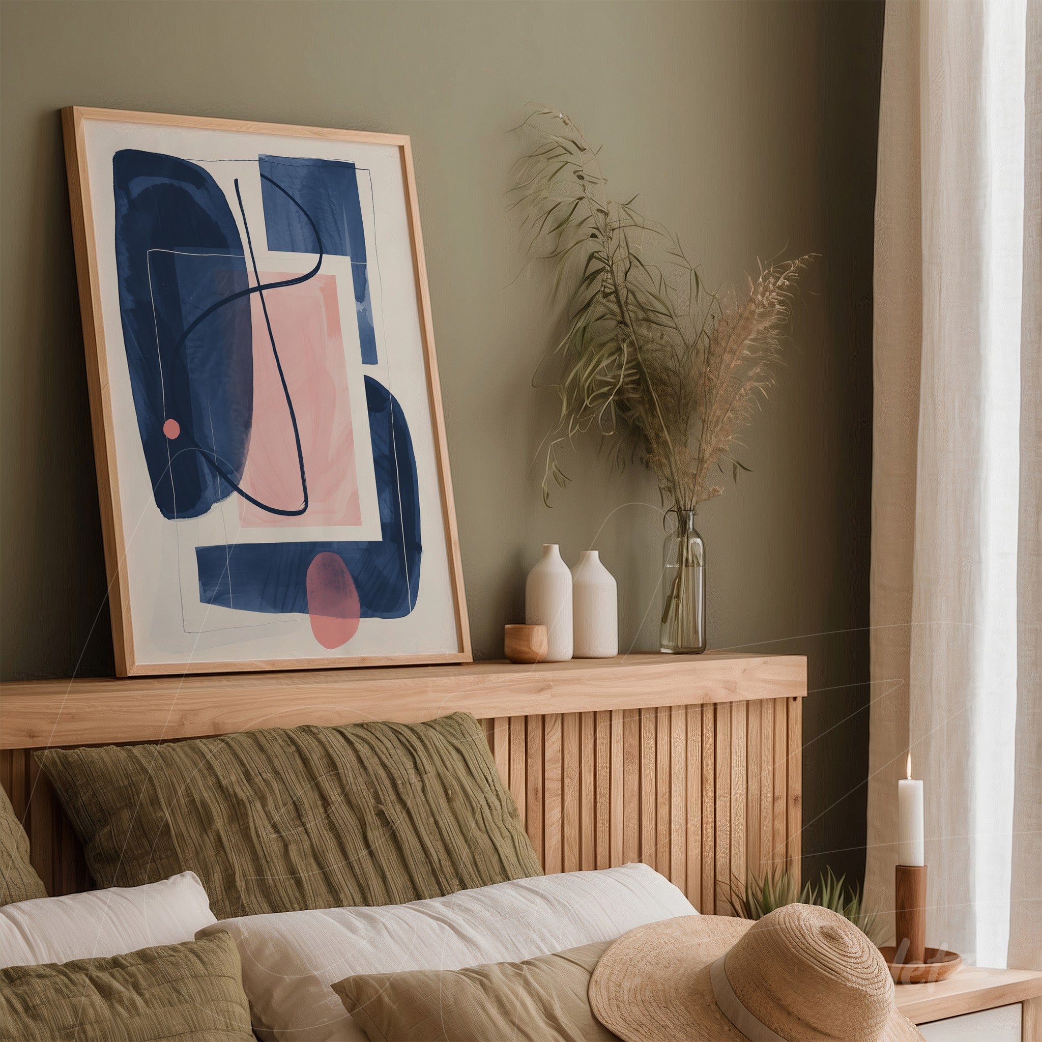 framed abstract art in shades of blue and pink, displayed on a light wooden headboard