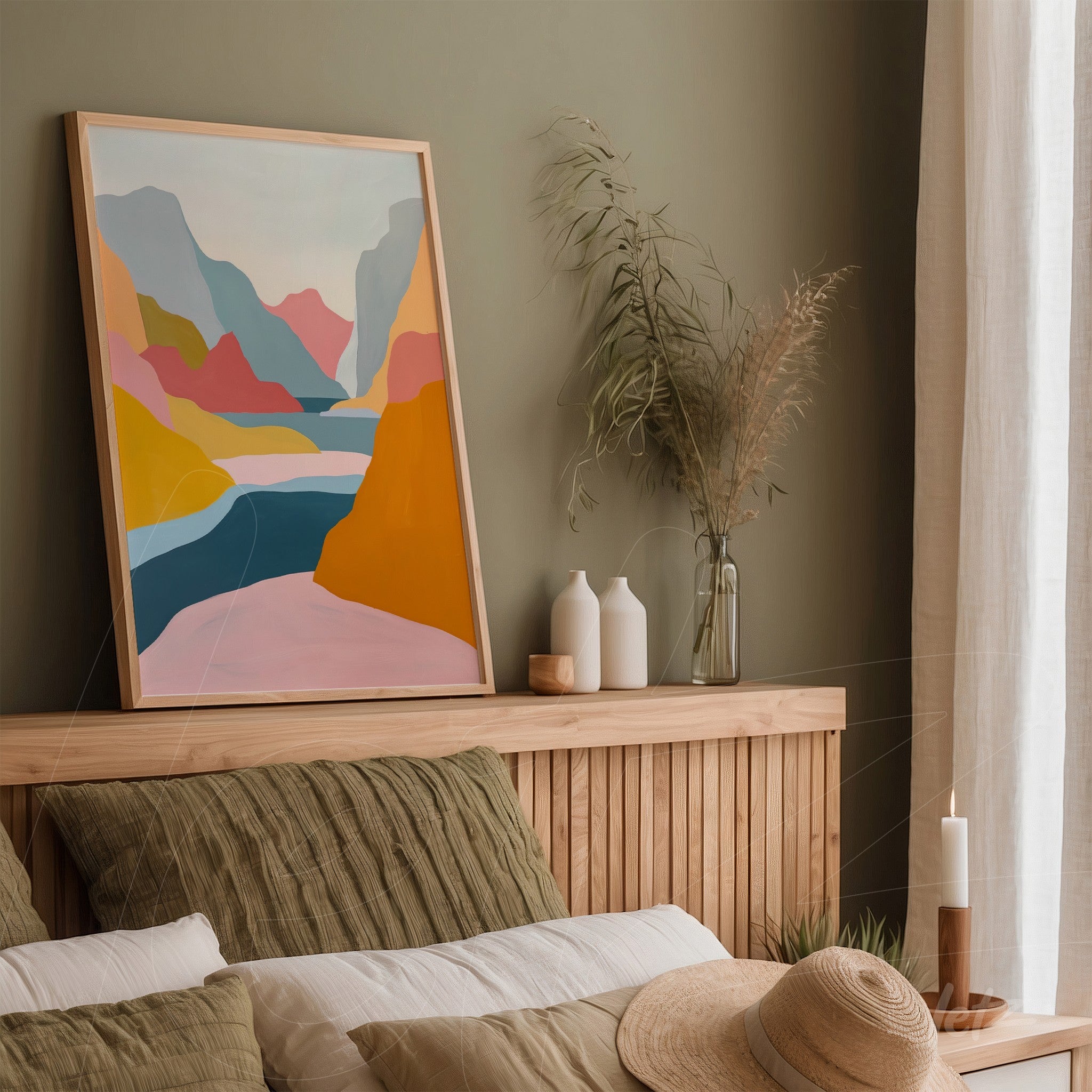 framed abstract art featuring a colorful landscape leaning against a green wall