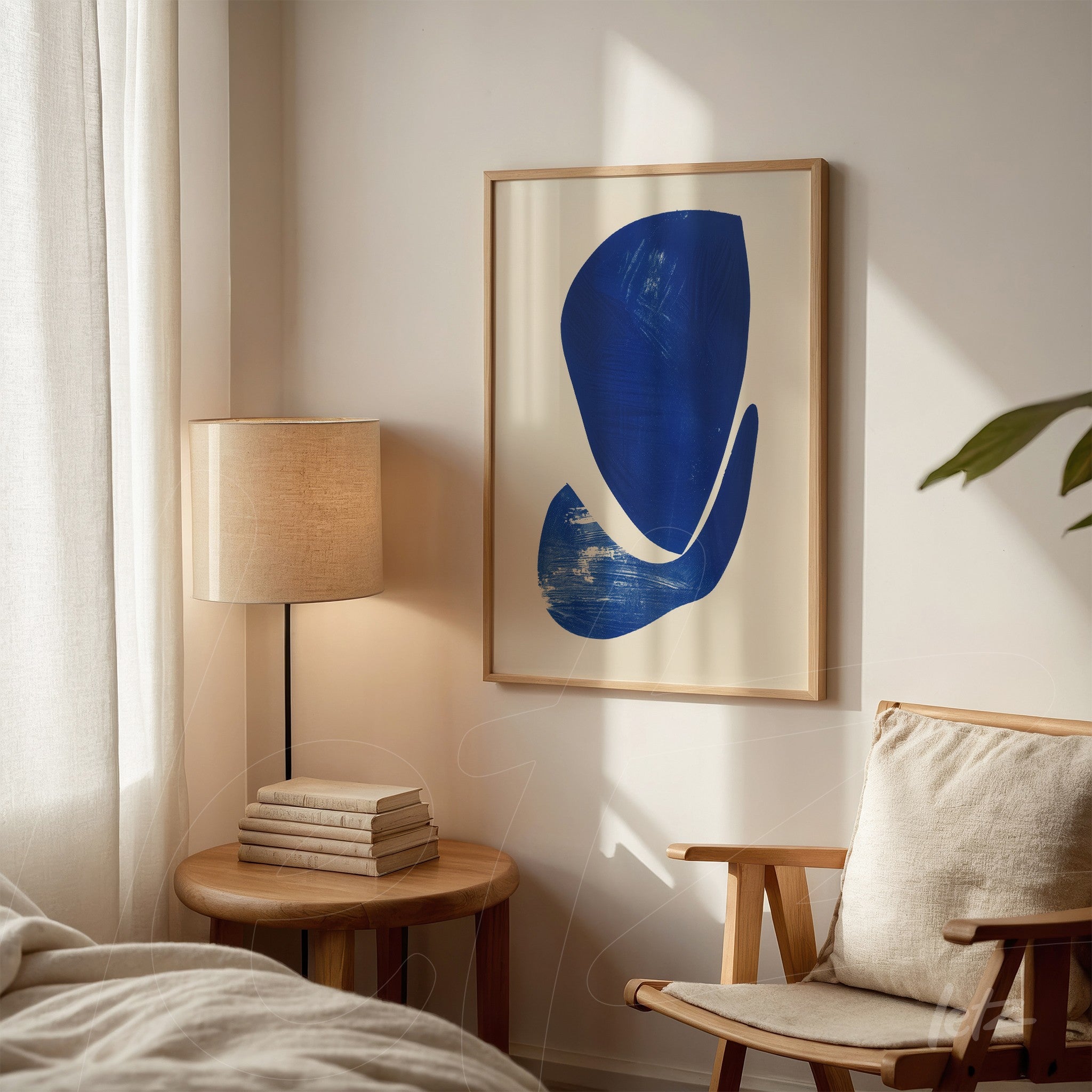 abstract wall art in blue framed with light wood, displayed in a cozy setting next to a lamp