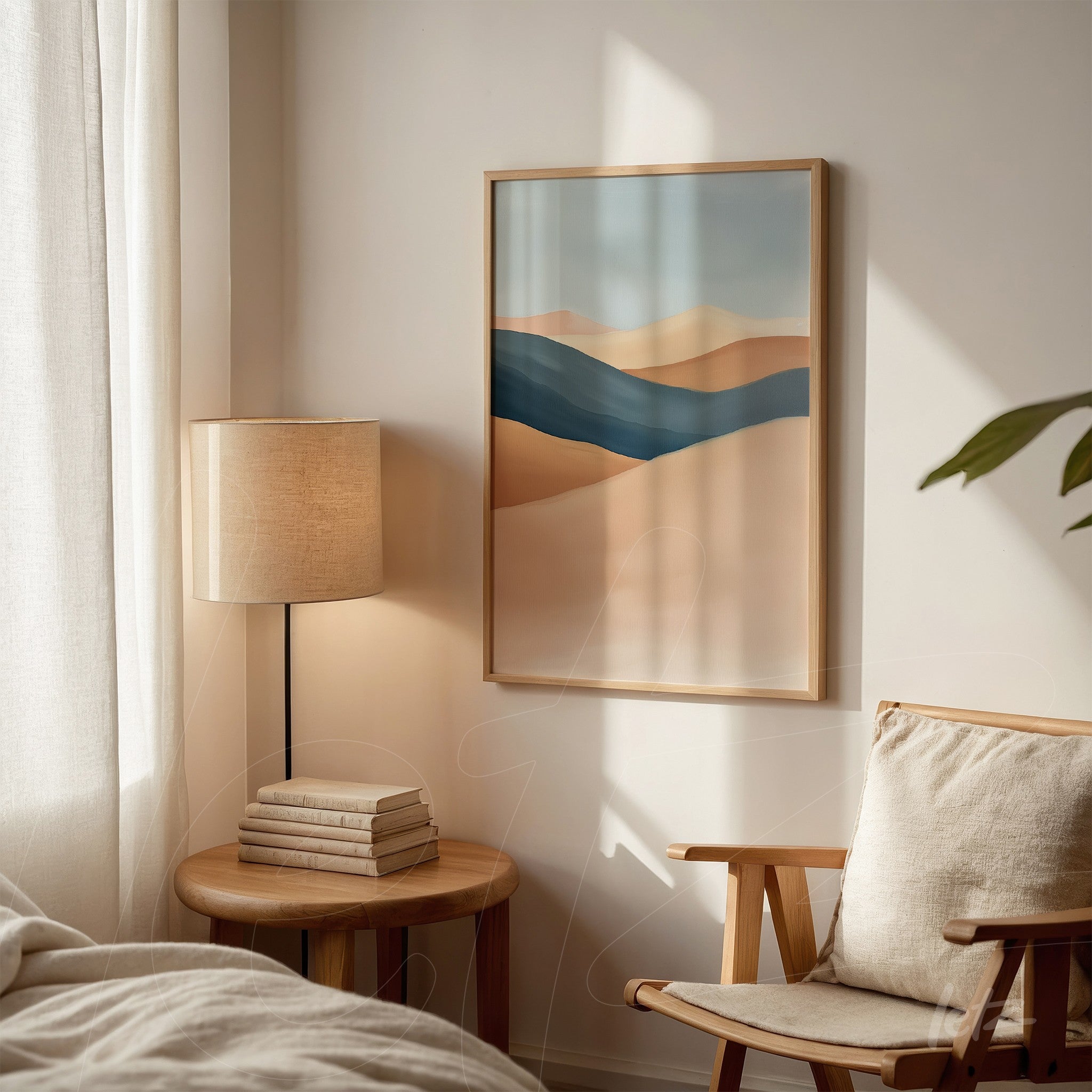 abstract art print in shades of blue and beige in a light wood frame hanging on a neutral wall next to a lamp and chair