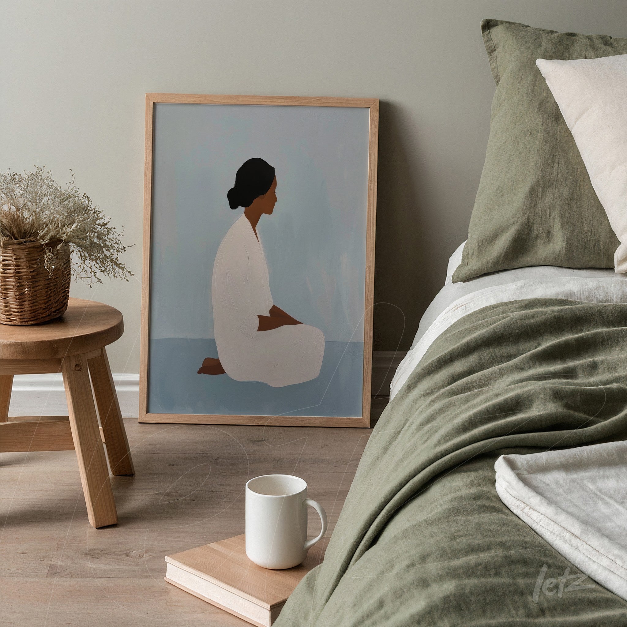 minimalist wall art depicting a seated woman in neutral tones, framed in a light wood frame, positioned beside a bed with green bedding