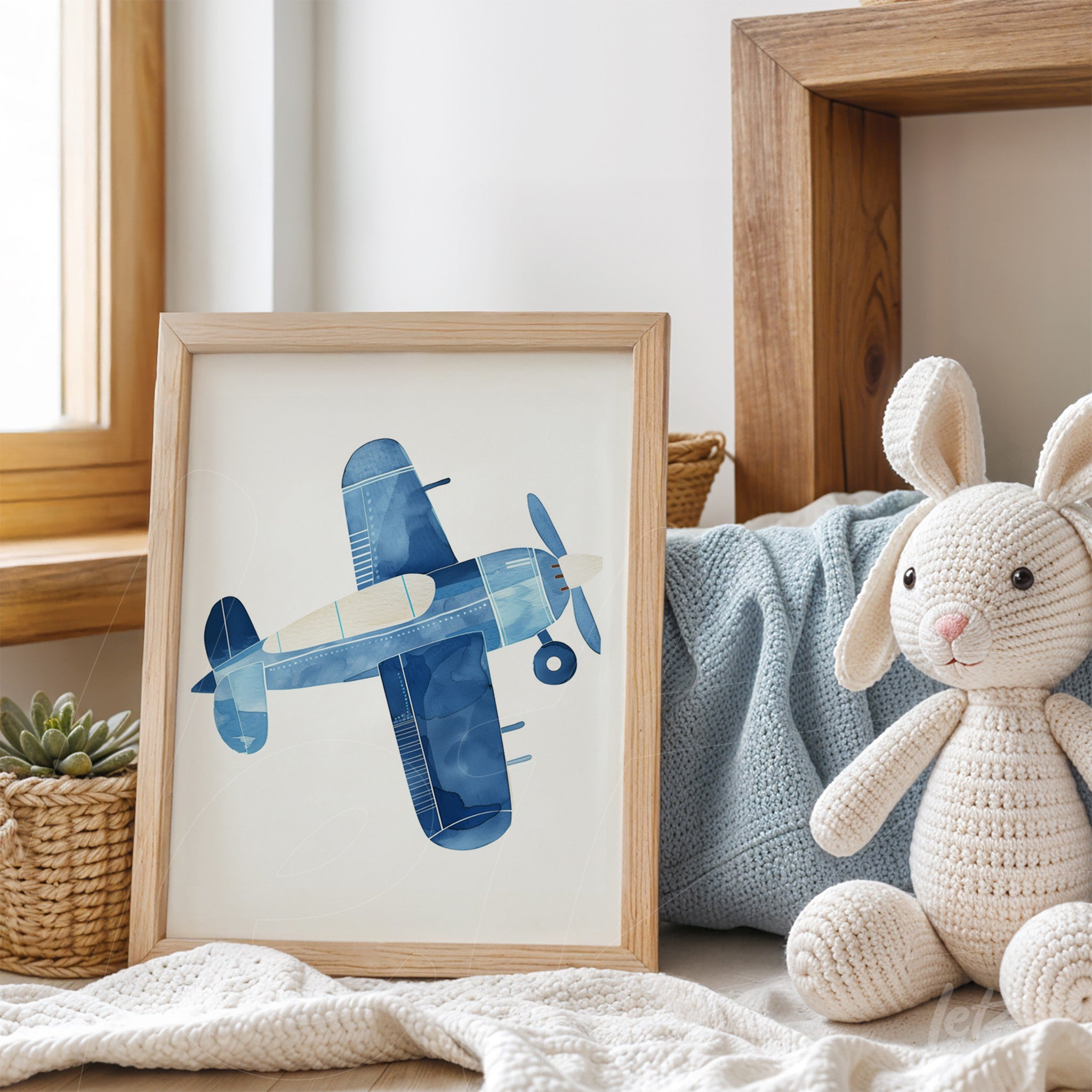 decorative art print of a stylized airplane in shades of blue within a light wood frame