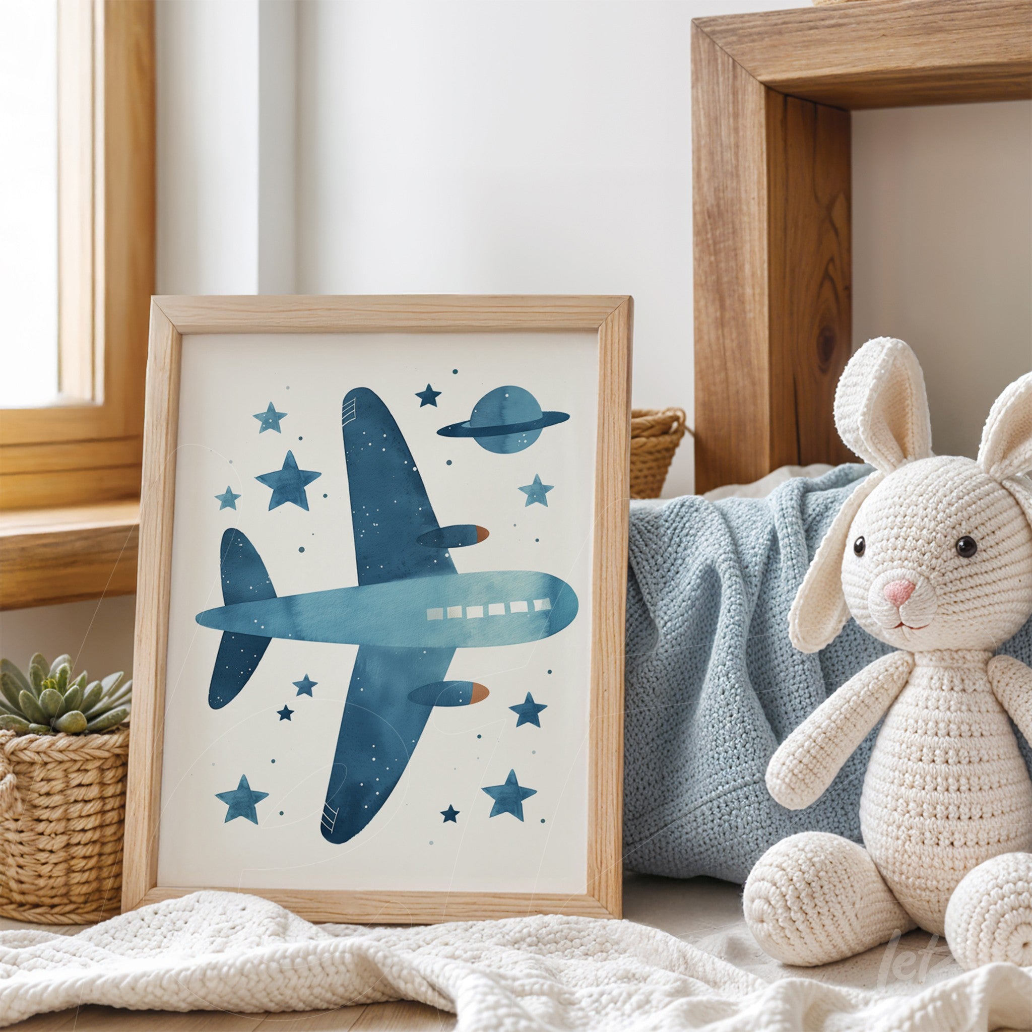 framed artwork featuring a blue airplane and stars on a light background with a light wood frame