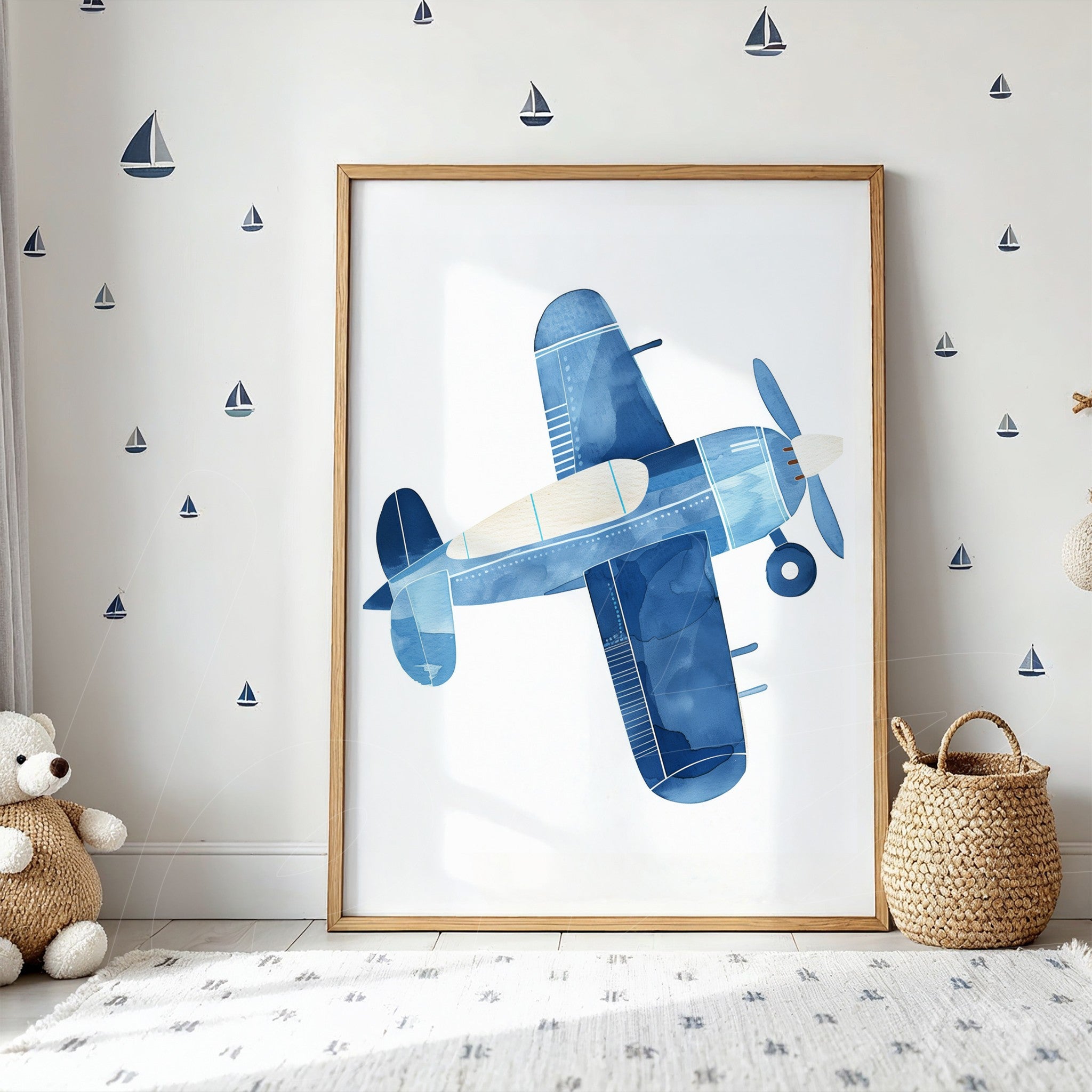 framed wall art of a blue airplane in light wood frame displayed in a room with wall decor of sailboats
