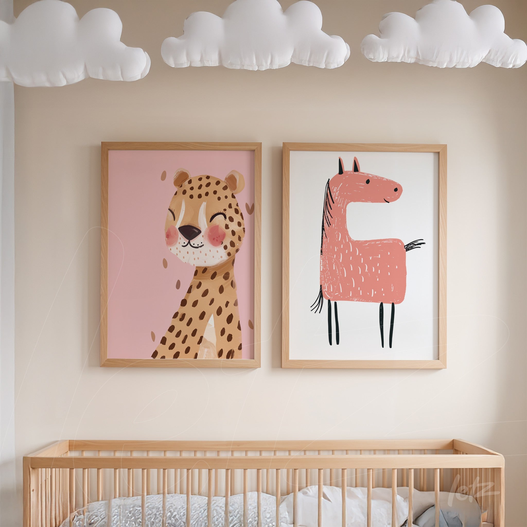 composition of framed wall art featuring a happy leopard on pink background and a stylized horse in pink on white background, displayed in light wood frames in a nursery setting