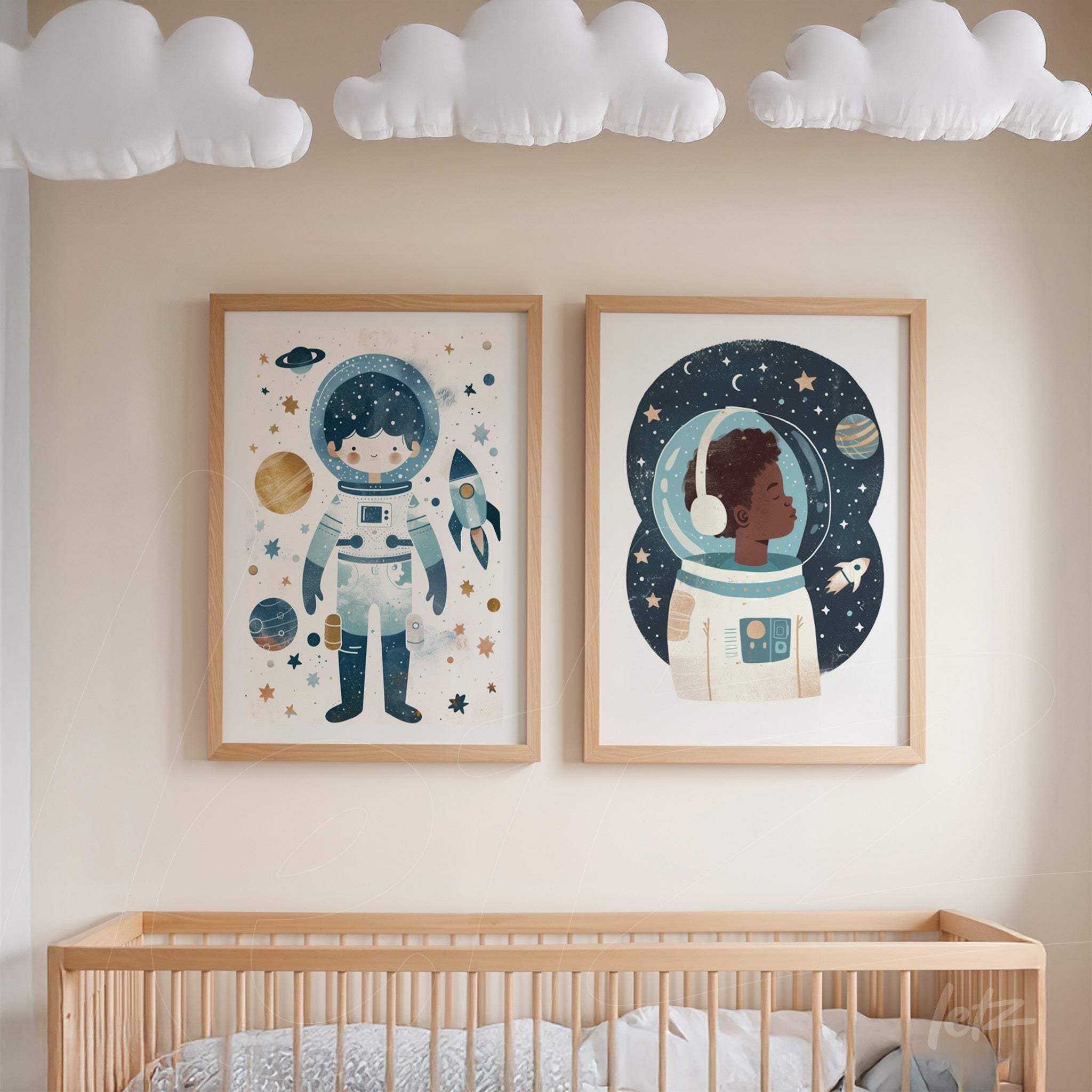 composition of two framed artworks featuring astronaut illustrations in light wood frames displayed above a crib in a nursery