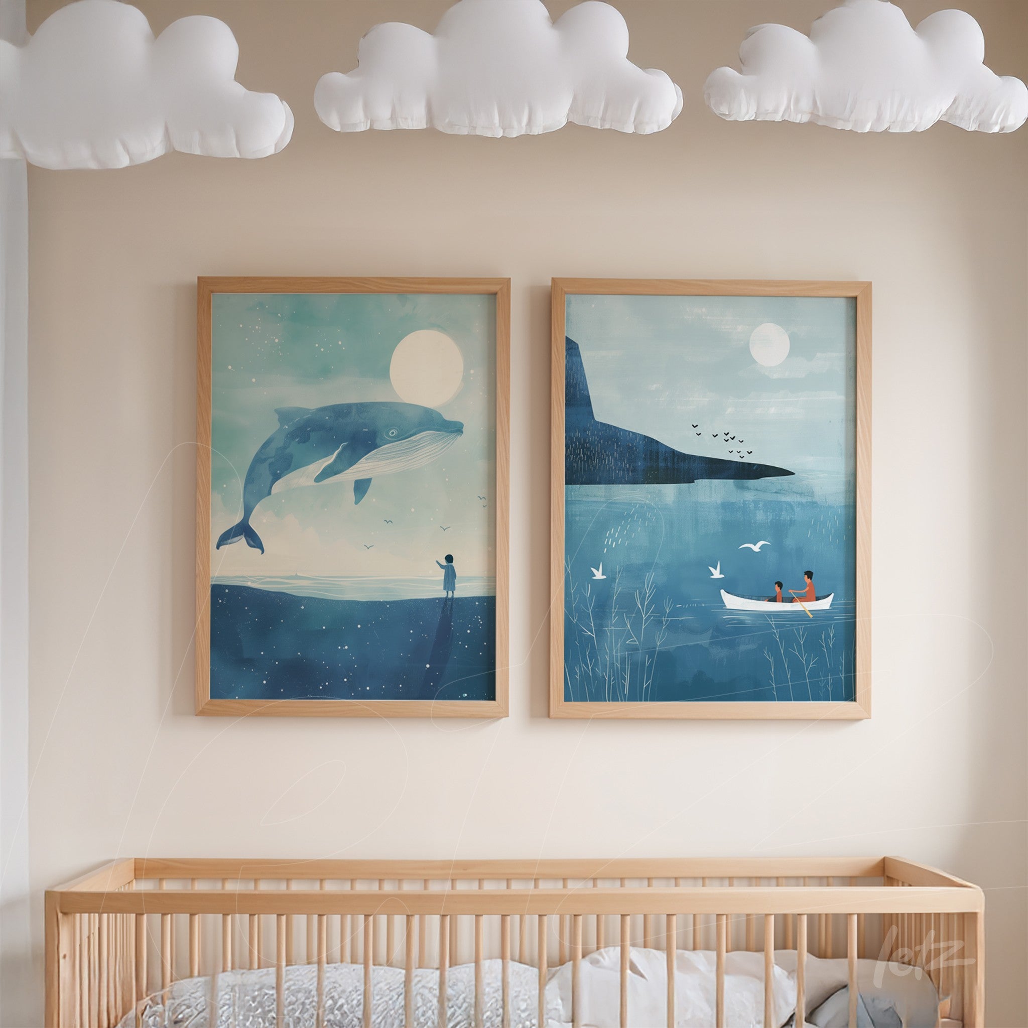 pair of framed artworks with aquatic illustrations in light wood frames, featuring a giant whale under a night sky on the left and a scene of fishermen on a serene lake with mountains in the background on the right